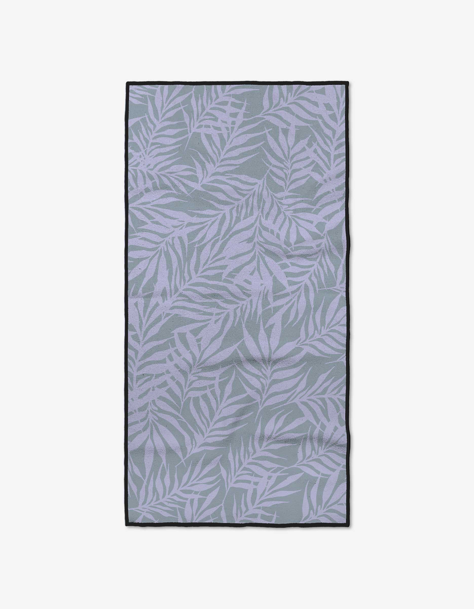 The GEOMETRY Purple Branches towel features a gray background with a light purple leafy pattern and a thin black border. Crafted from ultra-absorbent recycled materials, it delivers top performance and eco-friendly sustainability.