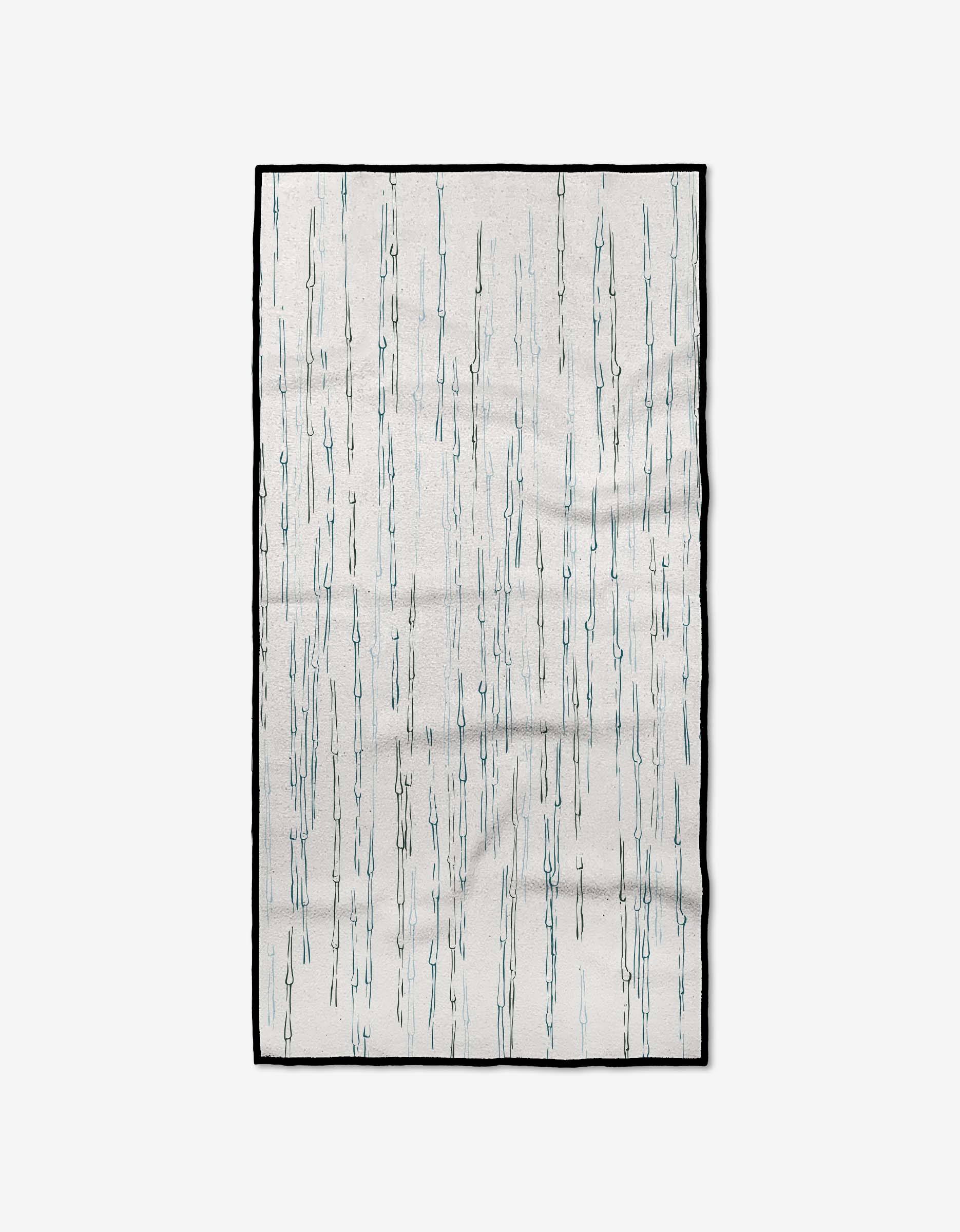 The GEOMETRY Stilts Fitness Towel is rectangular, white, and made from recycled materials. It features thin vertical blue lines resembling falling rain, with a slim black border.