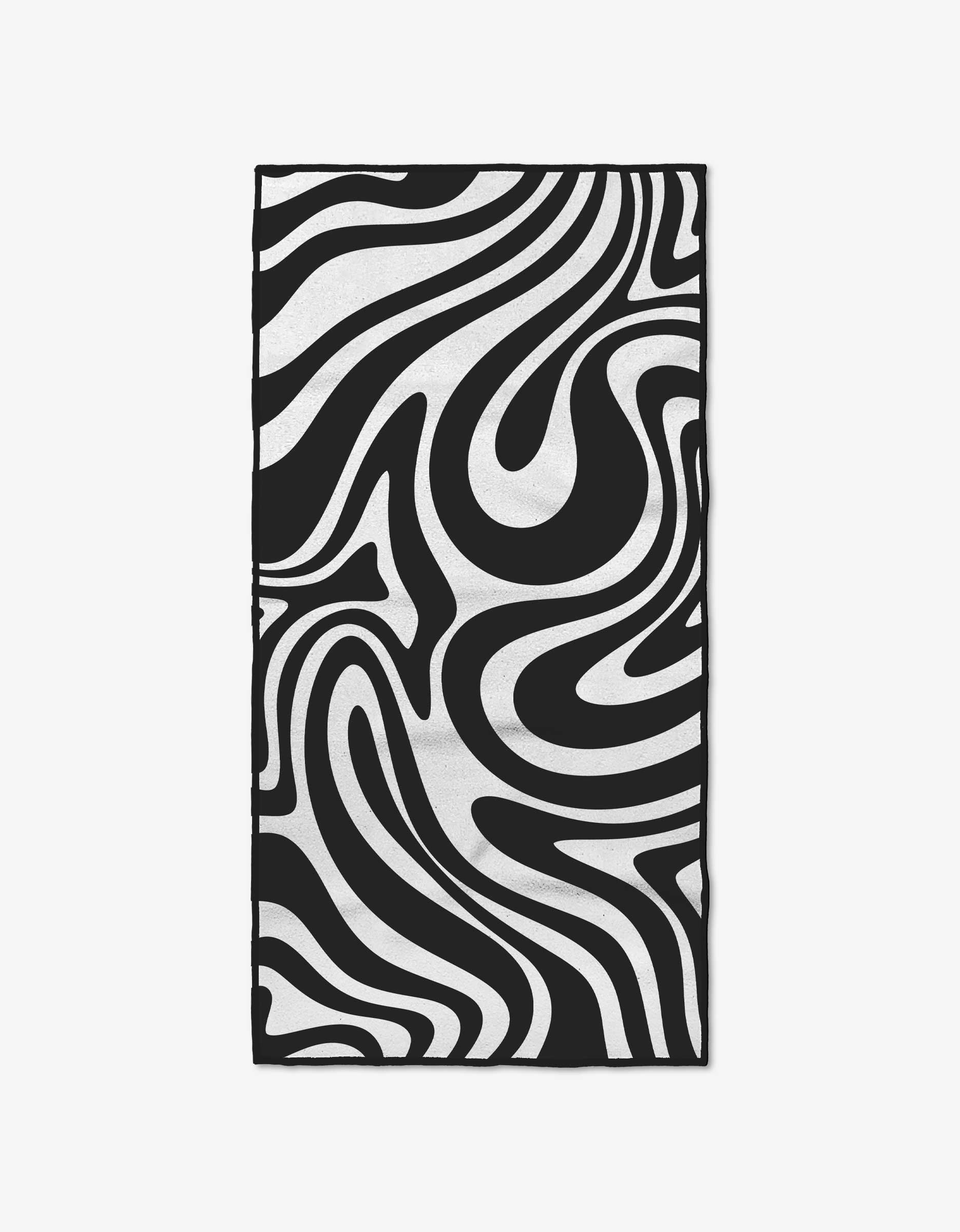 The GEOMETRY Swirls fitness towel features a rectangular shape with an ultra-absorbent surface and a black and white abstract wavy design, resembling zebra stripes with swirling, curved lines.
