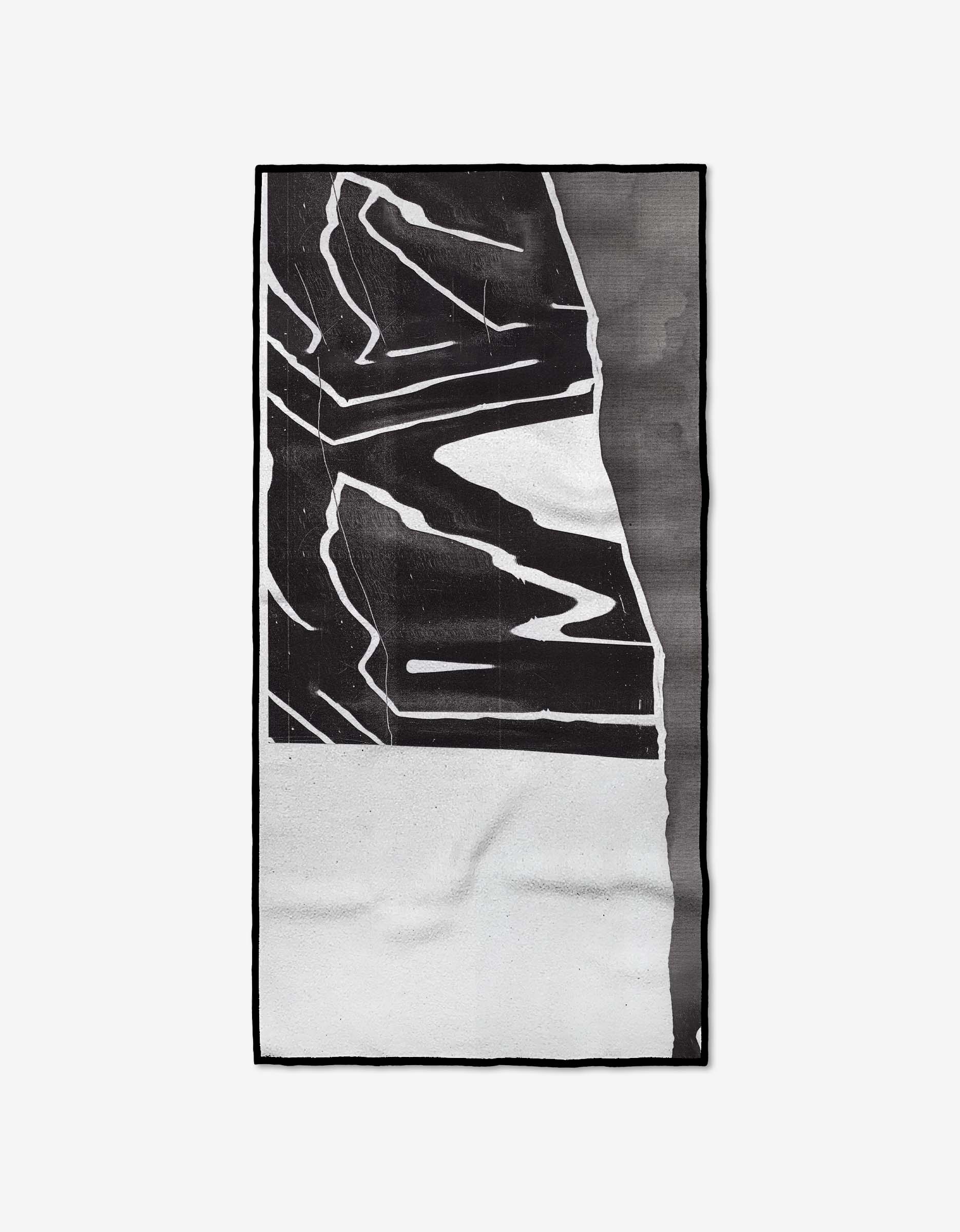 The Where rug by GEOMETRY showcases striking black-and-white abstract geometric shapes and lines on a plain background, crafted from recycled materials for a modern, eco-friendly statement.