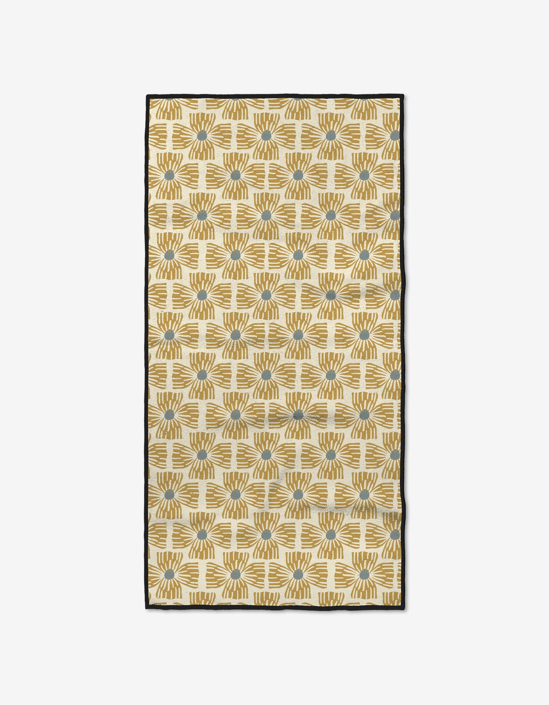 The Wildflower by Ash Cascade is a rectangular yellow and beige textile made from recycled materials, featuring a geometric pattern with blue accents, a black border, and abstract sunburst-like forms arranged in a grid.