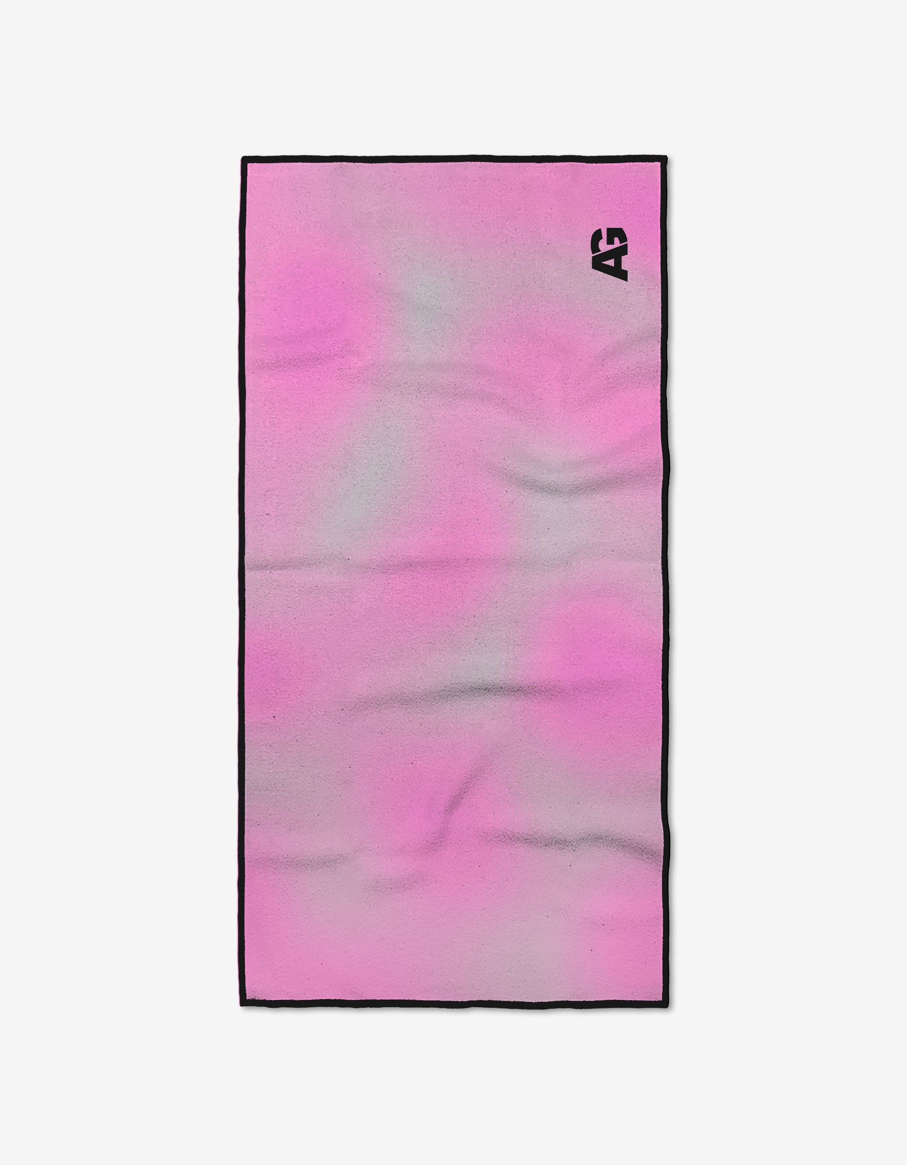 The Wonder Woman towel by Ashley Guarrasi is rectangular with a pink and light gray gradient, black edge trim, and a black AG logo in the top right. Made from ultra-absorbent recycled materials, its shown flat on a white background.