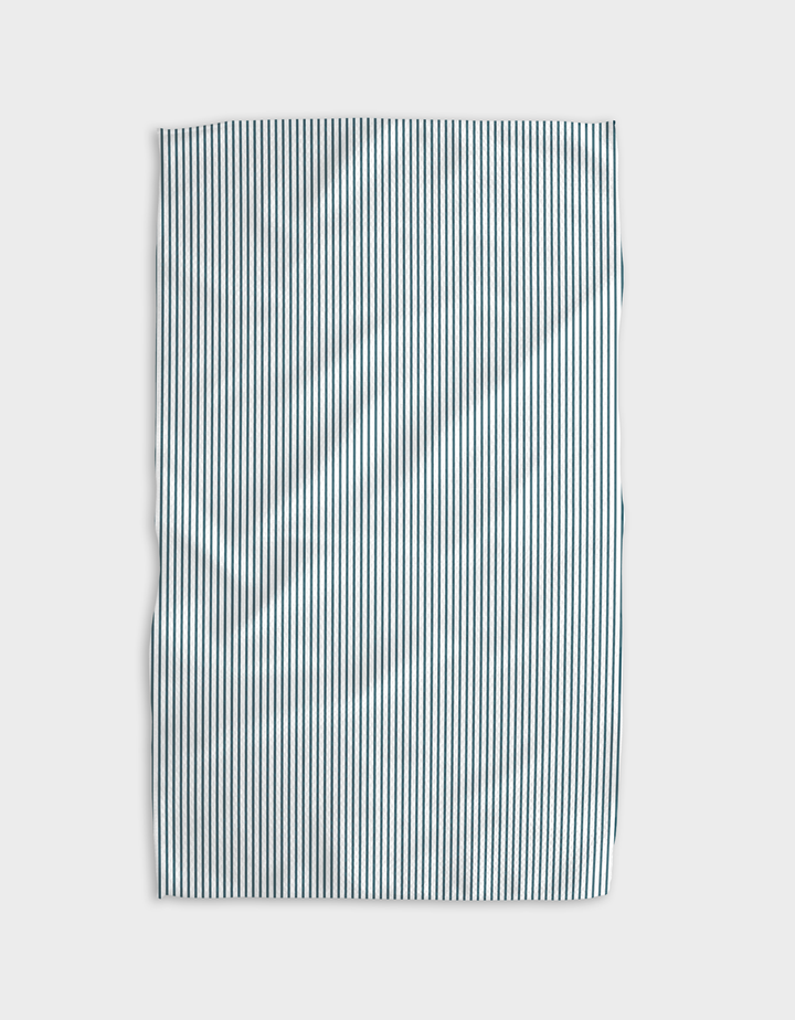 The Buy Guide’s Get In Line - Emerald Geoweave tea towel, made from recycled materials, features thin vertical black and white stripes and is slightly wrinkled, shown on a plain light background.