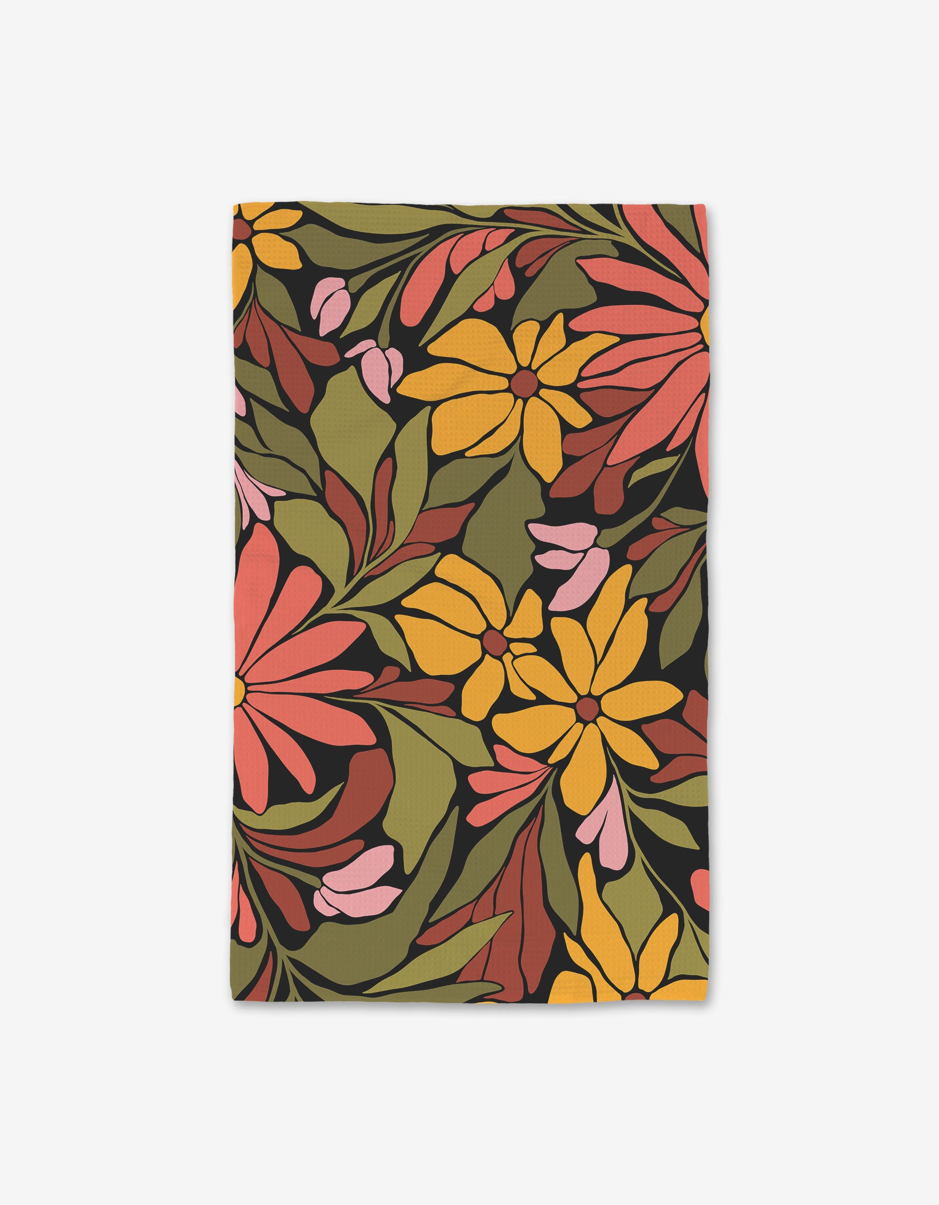 The GEOMETRY Blooming Black is a rectangular cloth napkin made from recycled materials, featuring a striking pattern of large yellow, orange, and pink flowers with green leaves on an olive background.