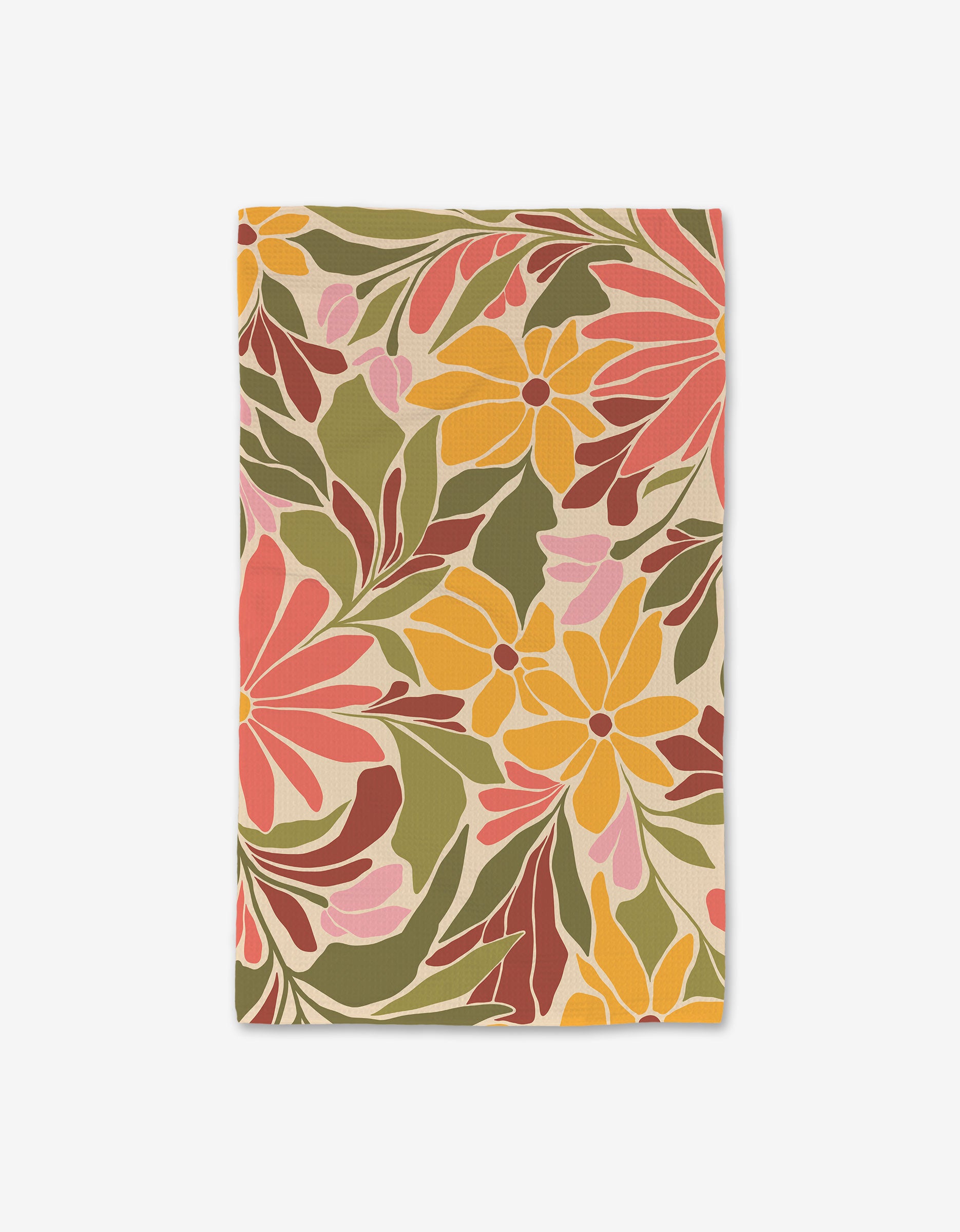 The GEOMETRY Blooming Tan is a rectangular Luxe Hand Towel made from recycled materials, showcasing large yellow, pink, and red flowers with green and brown leaves on a light background.