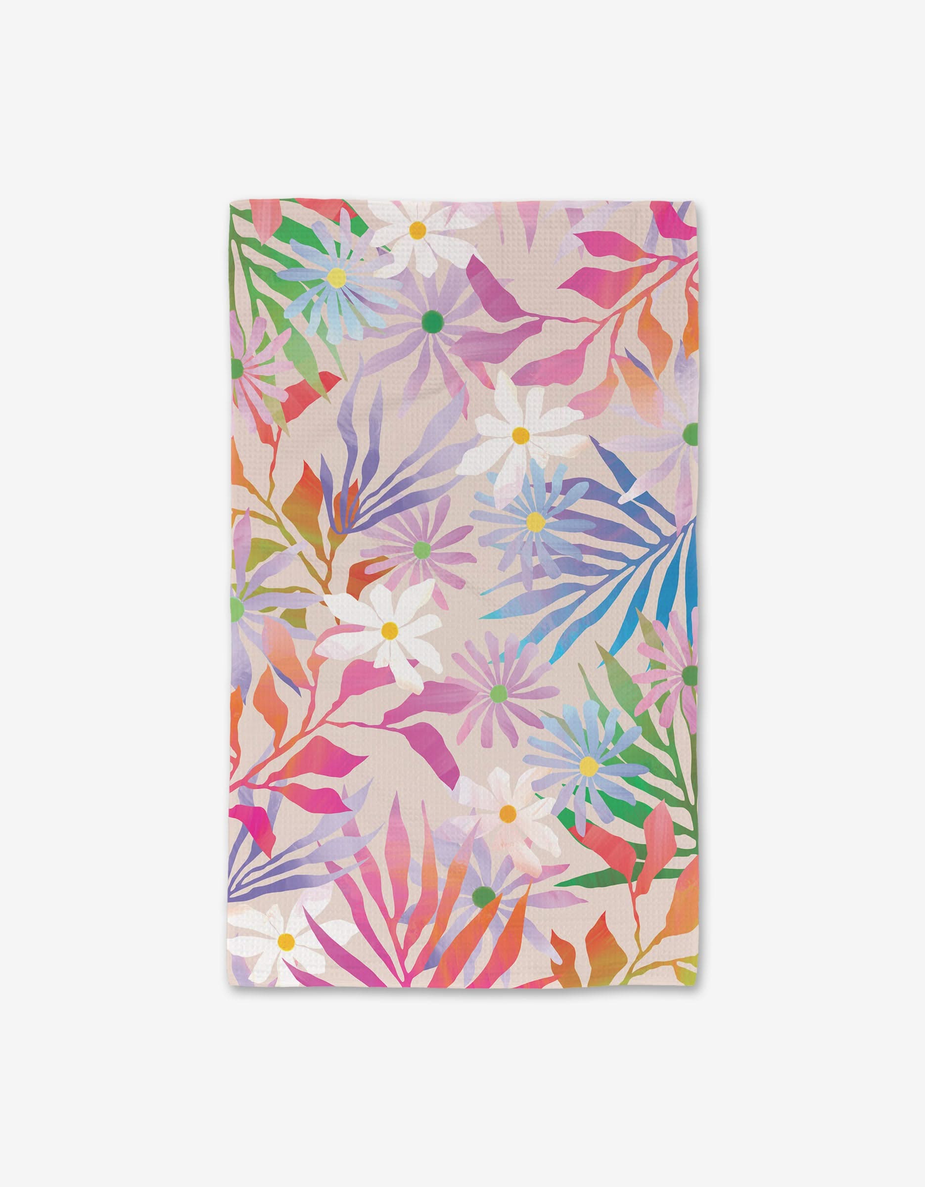 The GEOMETRY Bold Blossoms hand towel features a vibrant floral pattern with white daisies and multicolored leaves on a light pink background, made from ultra-absorbent recycled materials.