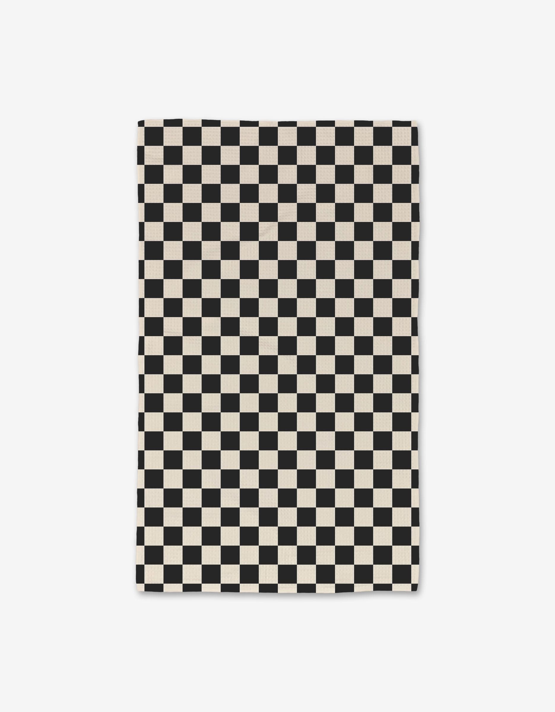 A GEOMETRY Checkered rectangular Luxe Hand Towel, made from ultra-absorbent recycled materials, features an evenly sized black and white checkerboard pattern and is shown laid flat on a white background.