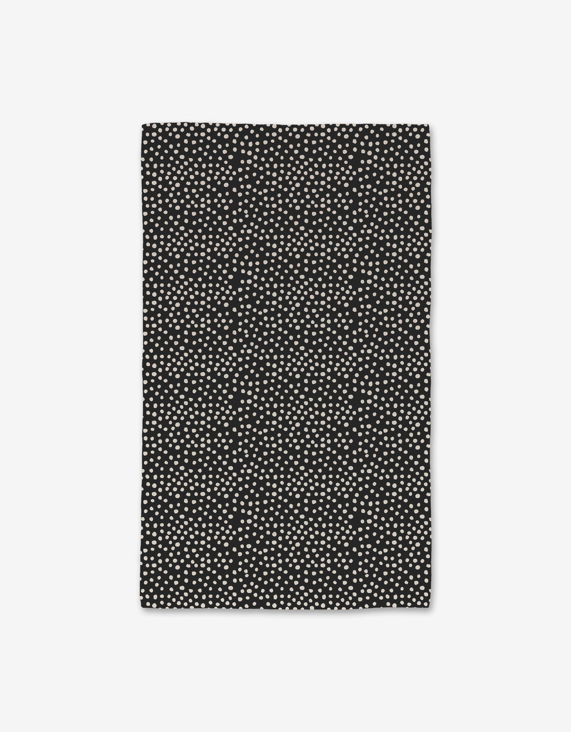 The GEOMETRY Dotty Black towel features a rectangular shape with small white dots on black, made with Geoweave technology for ultra-absorbency. Shown against a plain white background.