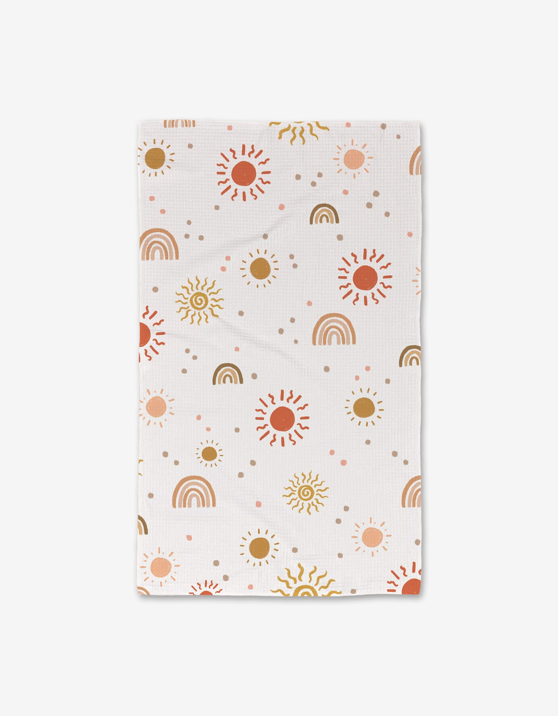 The GEOMETRY Happy Skies baby blanket, featuring suns, rainbows, and dots in orange, yellow, and brown on white with ultra-absorbent Geoweave technology, is shown laid flat on a white background.
