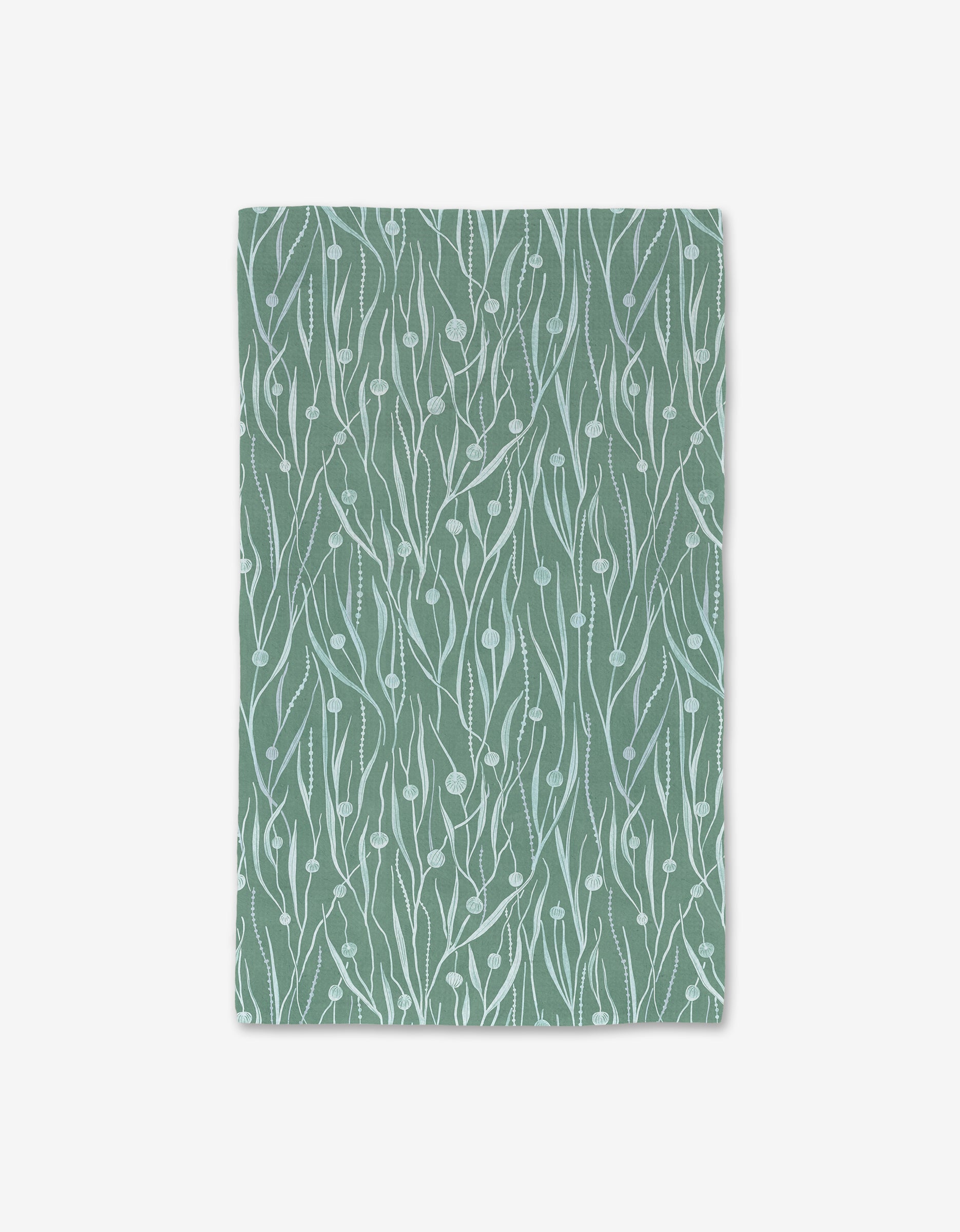 Kelp by Katie OShea is a green rectangular mat made from recycled materials, featuring a white abstract botanical pattern with wavy lines and small leaf shapes, shown on a plain white background.