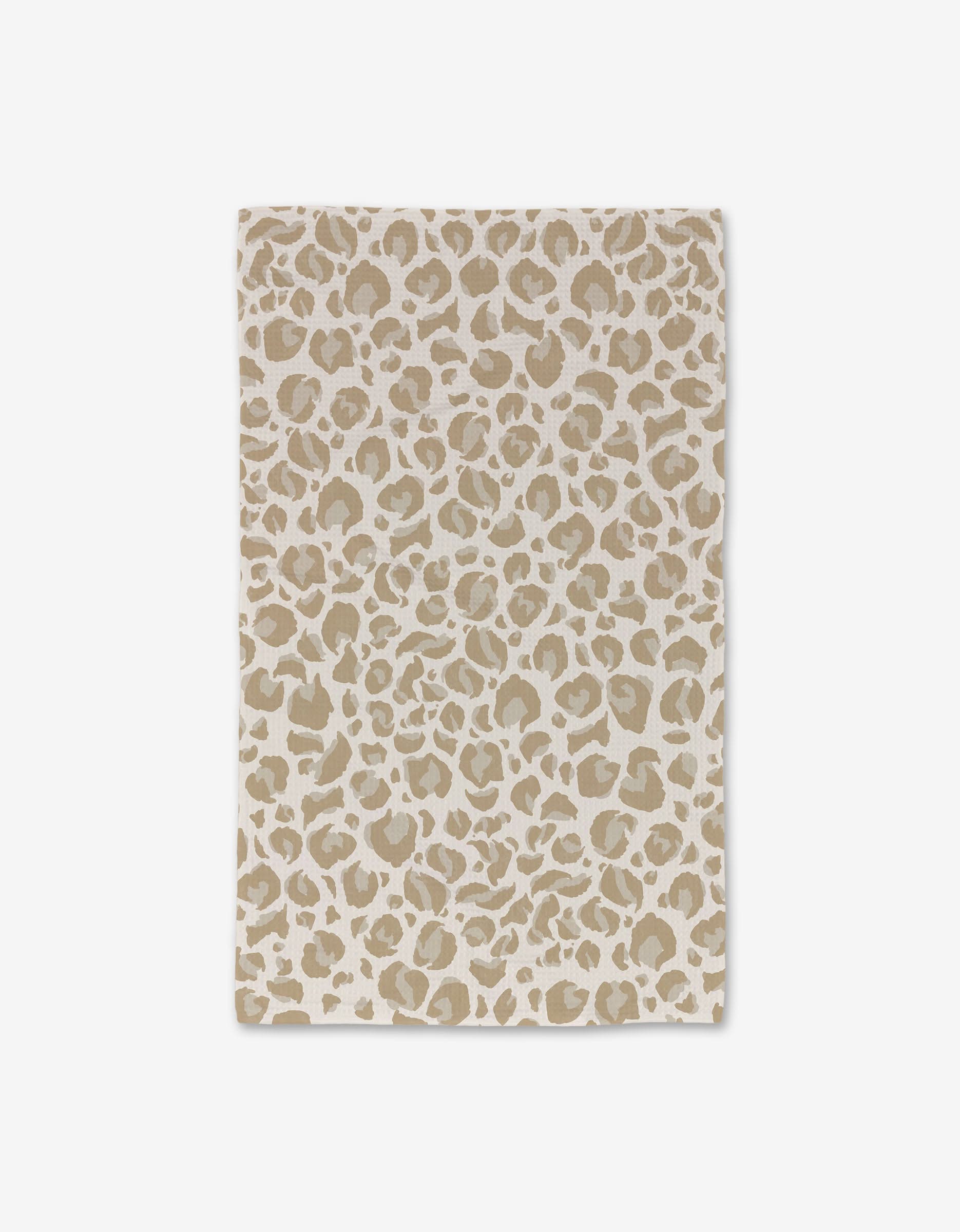 The GEOMETRY Light Leopard Luxe Hand Towel features a beige and white rectangular design with a leopard print pattern, crafted with Geoweave technology and shown flat on a white background.