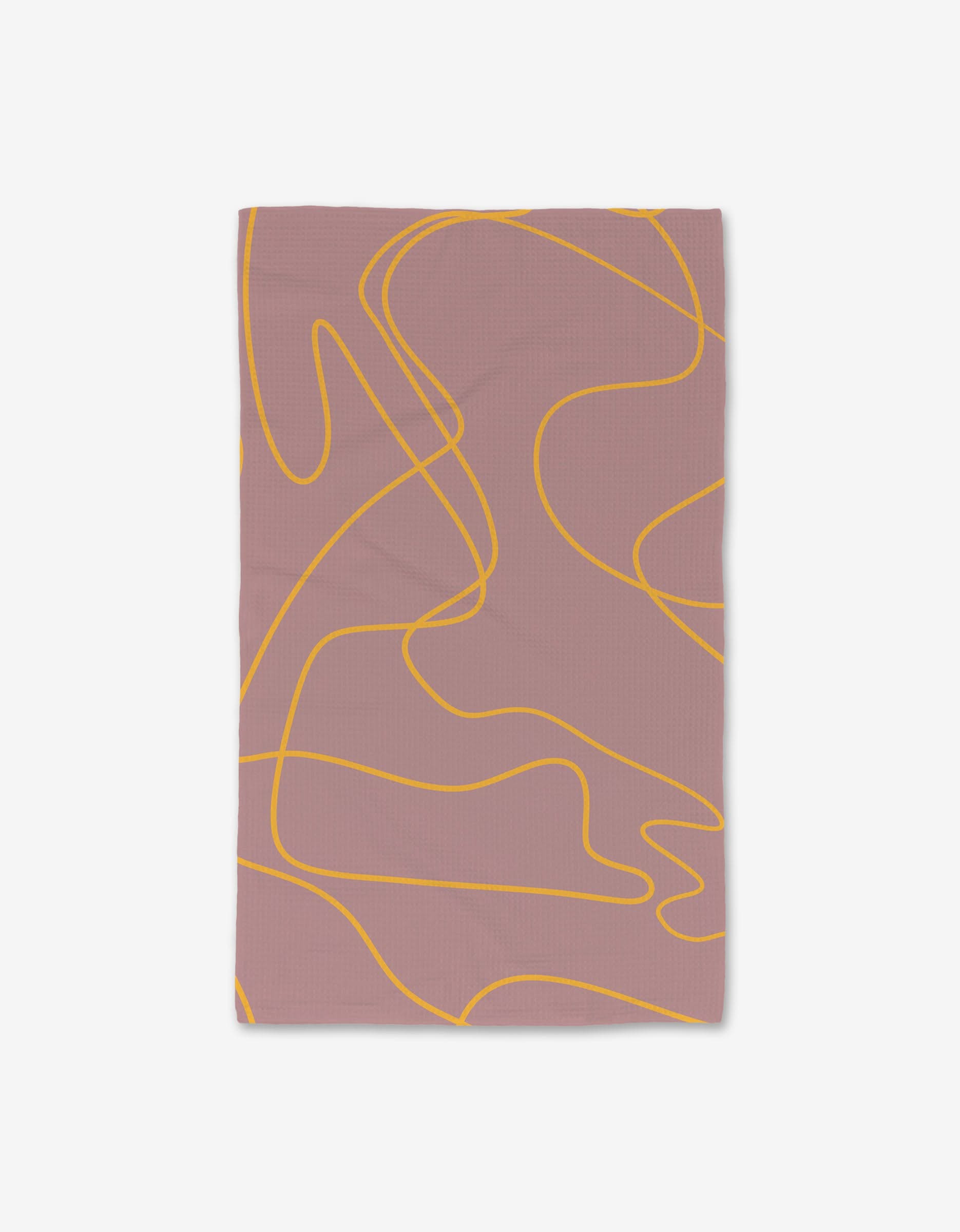 The GEOMETRY On The Mauve Luxe Hand Towel, made from recycled materials, features abstract wavy yellow lines on mauve and is displayed on a white background.