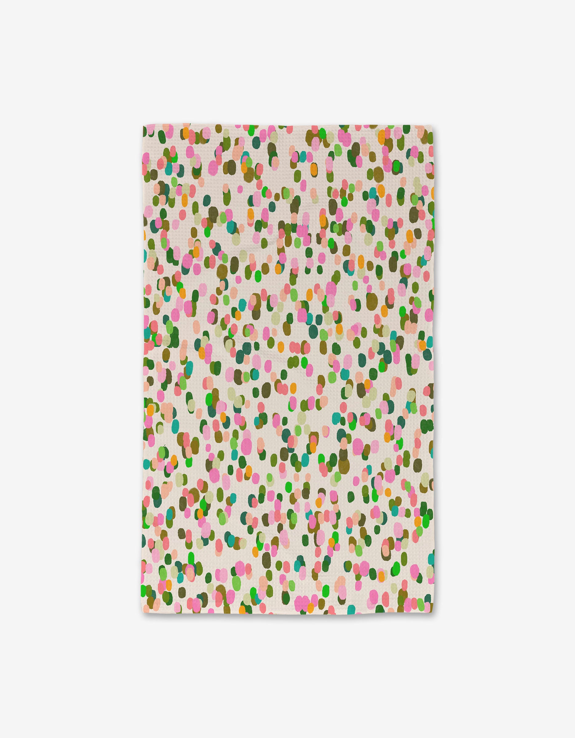 The GEOMETRY Spring Bloom napkin is a square cloth with a white background and evenly scattered multicolored dots in pink, green, orange, and brown, made from post-consumer recycled materials.