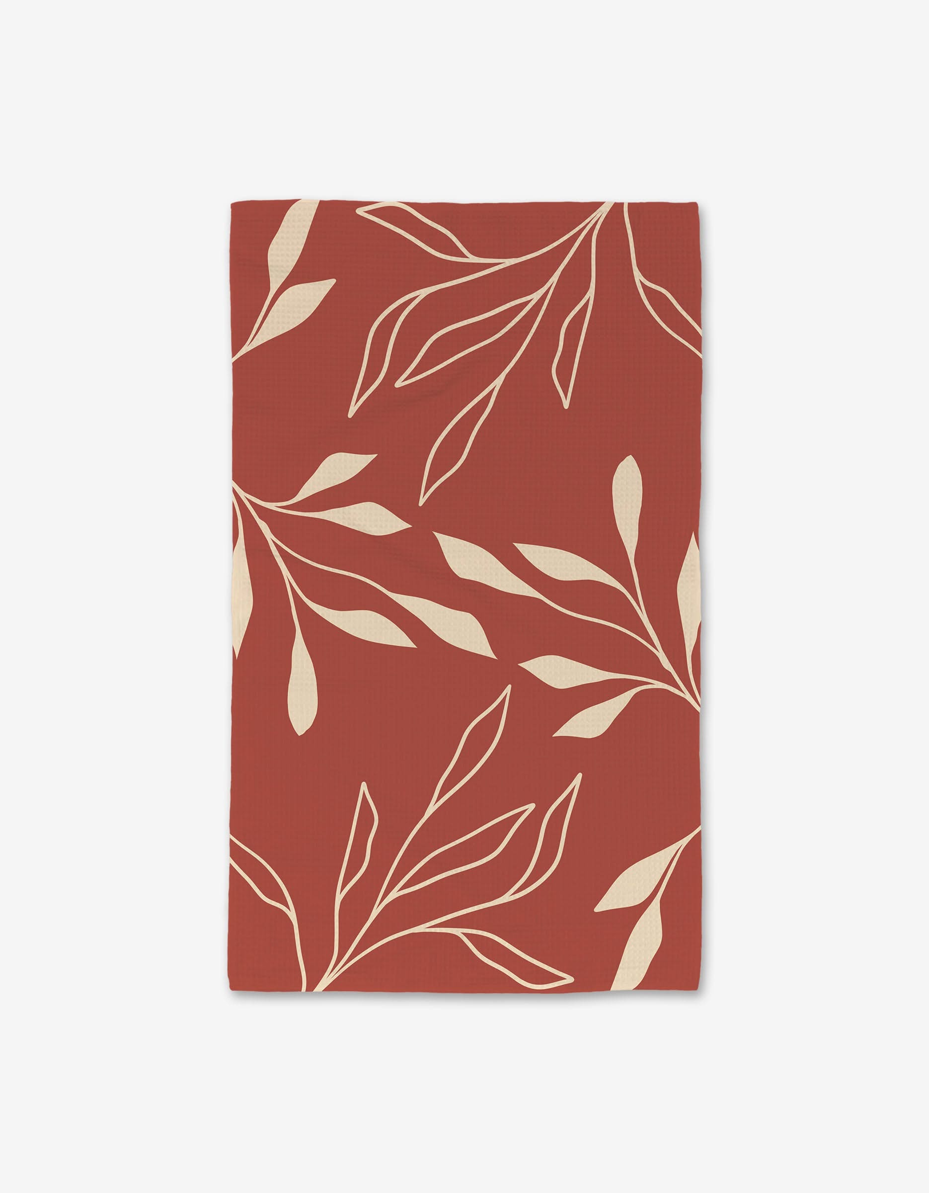 The GEOMETRY Sunset Bath is a rectangular Luxe Hand Towel featuring a rust-red background with cream-colored, stylized leaves and branches. Made with Geoweave technology, its modern design enhances the ultra-absorbent towel.