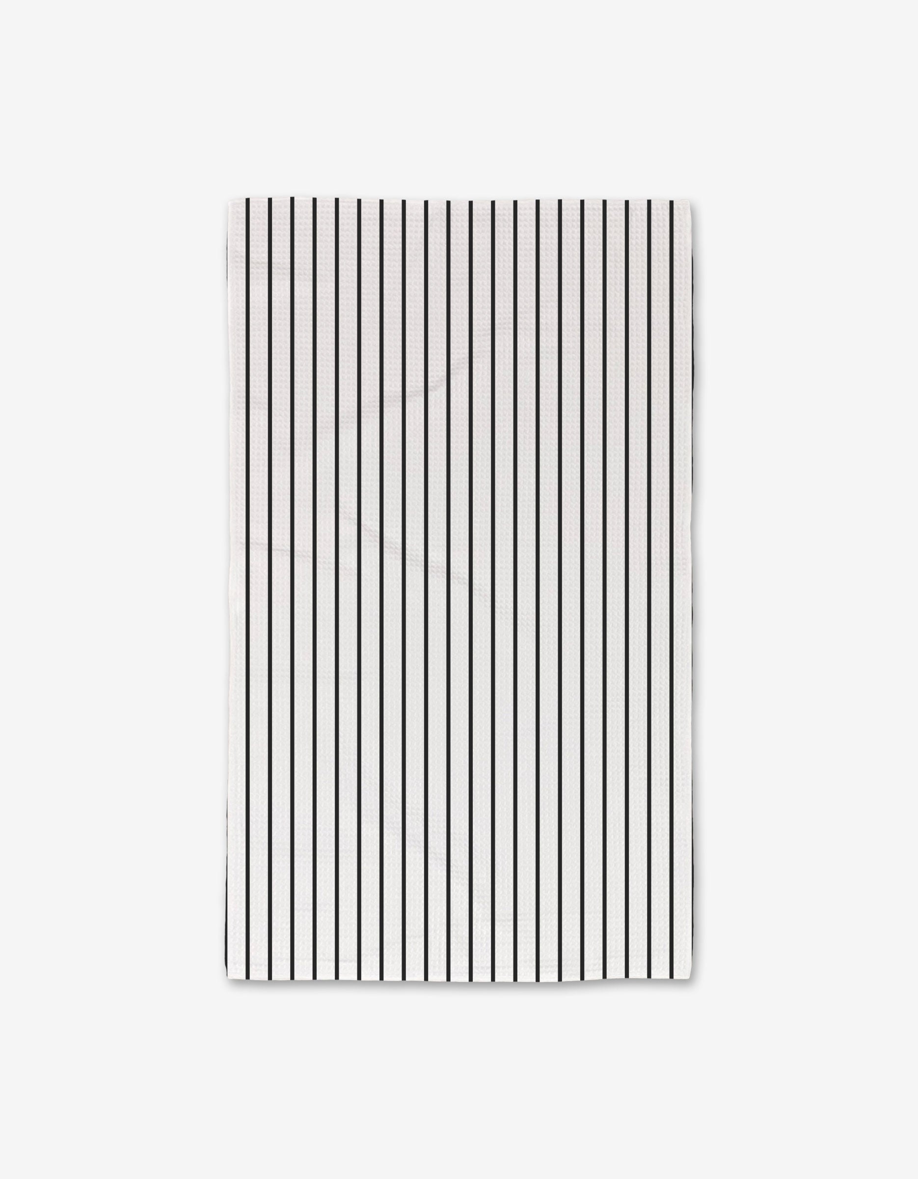 The GEOMETRY White Linen Luxe Hand Towel showcases evenly spaced vertical black stripes on white, made with ultra-absorbent Geoweave technology and displayed against a plain white background.