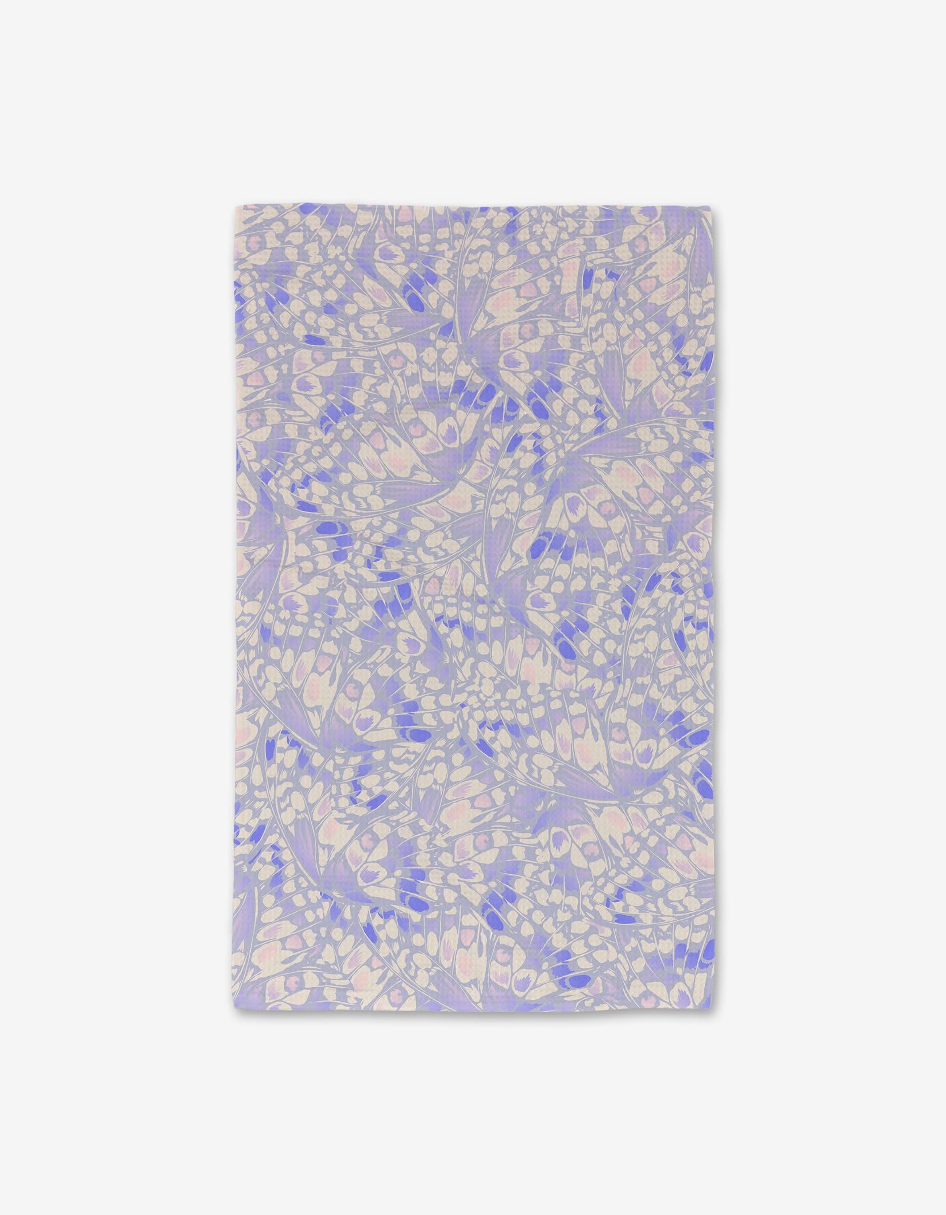 The Wings in the Wind Lavender hand towel by GEOMETRY features a pastel abstract leaf and seed pattern in lavender, blue, and pink on white, crafted with ultra-absorbent Geoweave Technology for a luxe touch.