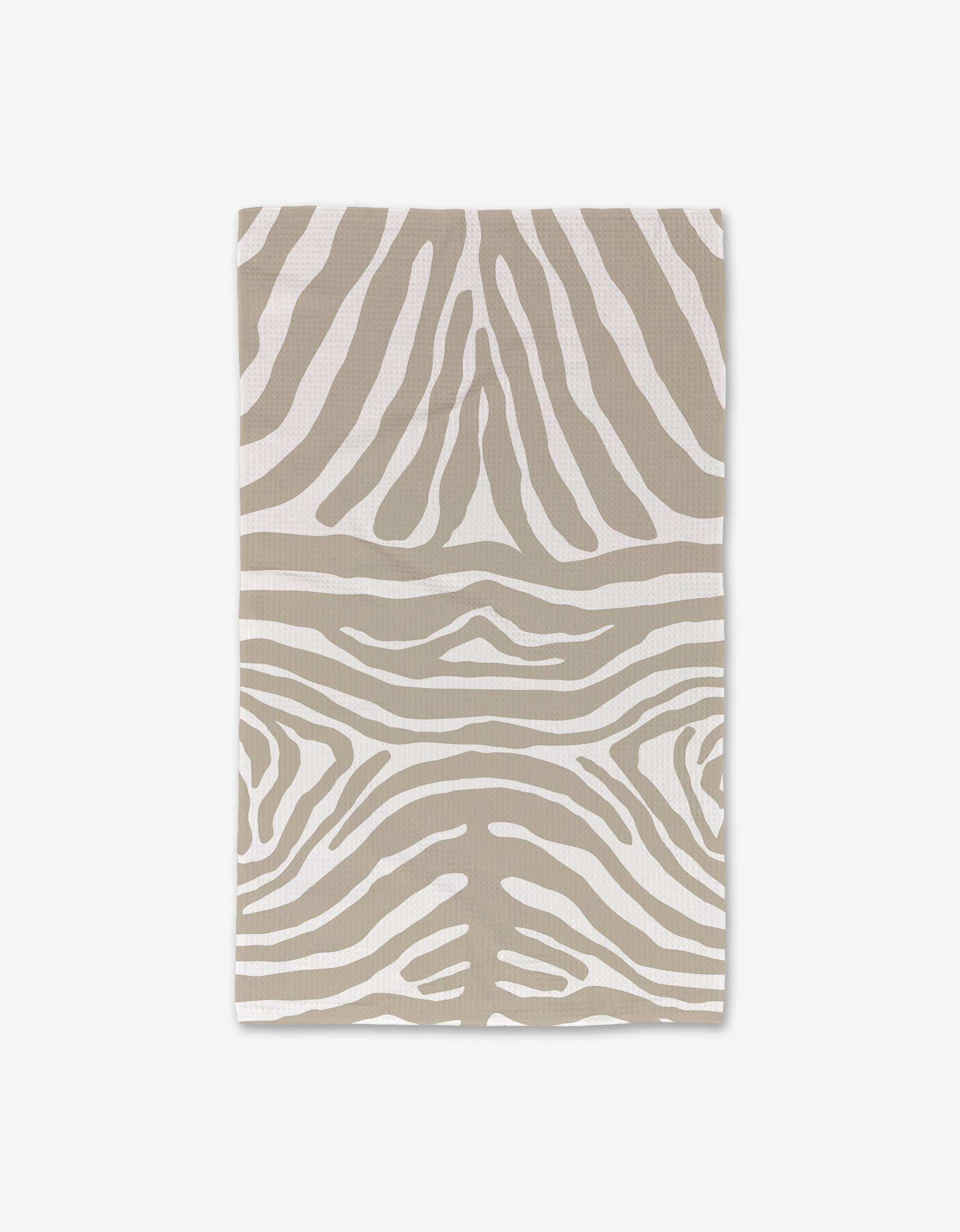 The GEOMETRY Zen Zebra is a rectangular hand towel with beige and white zebra stripes, shown flat on a white background. Crafted with Geoweave technology for ultra absorbency, it makes a stylish upgrade to your bath essentials.