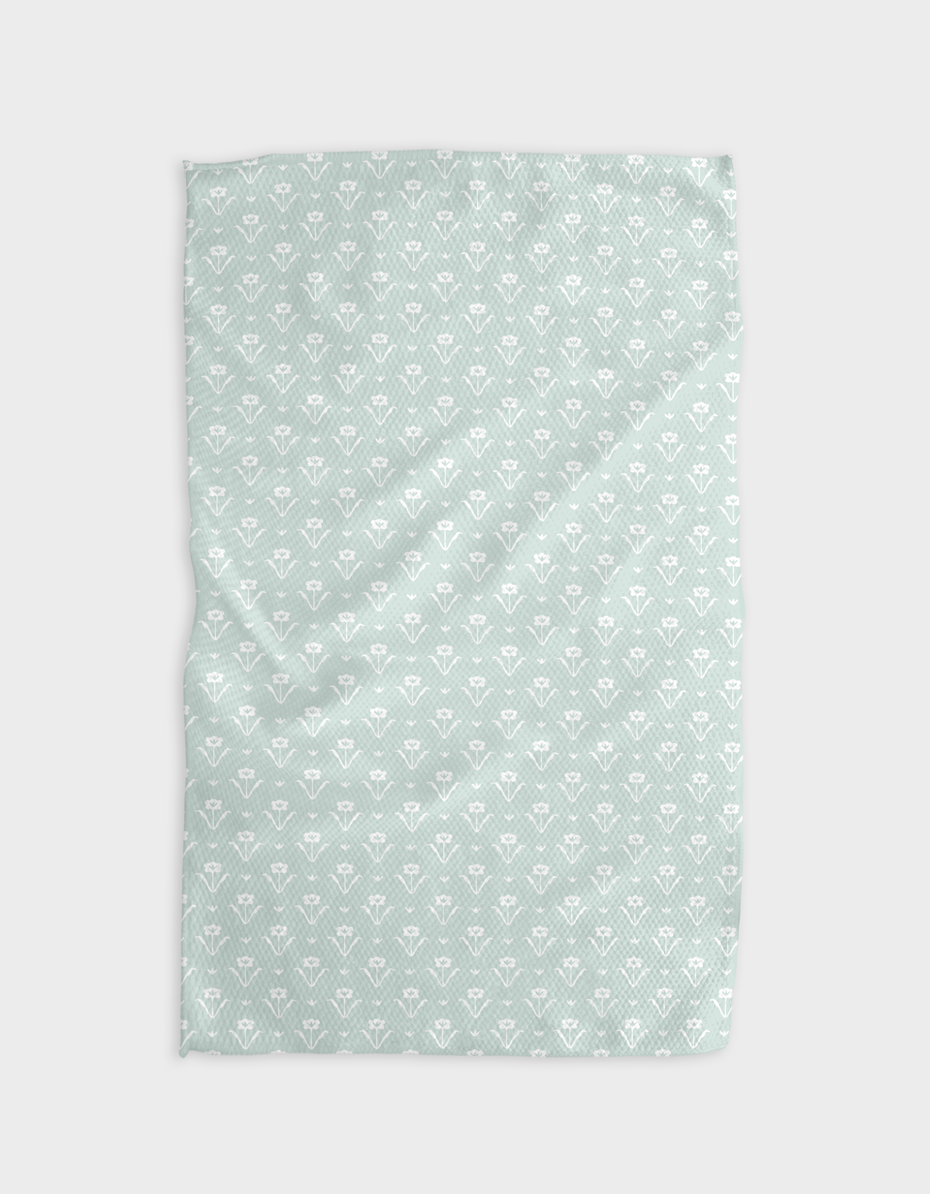 The Buy Guide’s Ladylike - Mint blanket features a soft Geoweave™ fabric in light mint with a white geometric pattern, shown slightly wrinkled on a white background for a modern look.