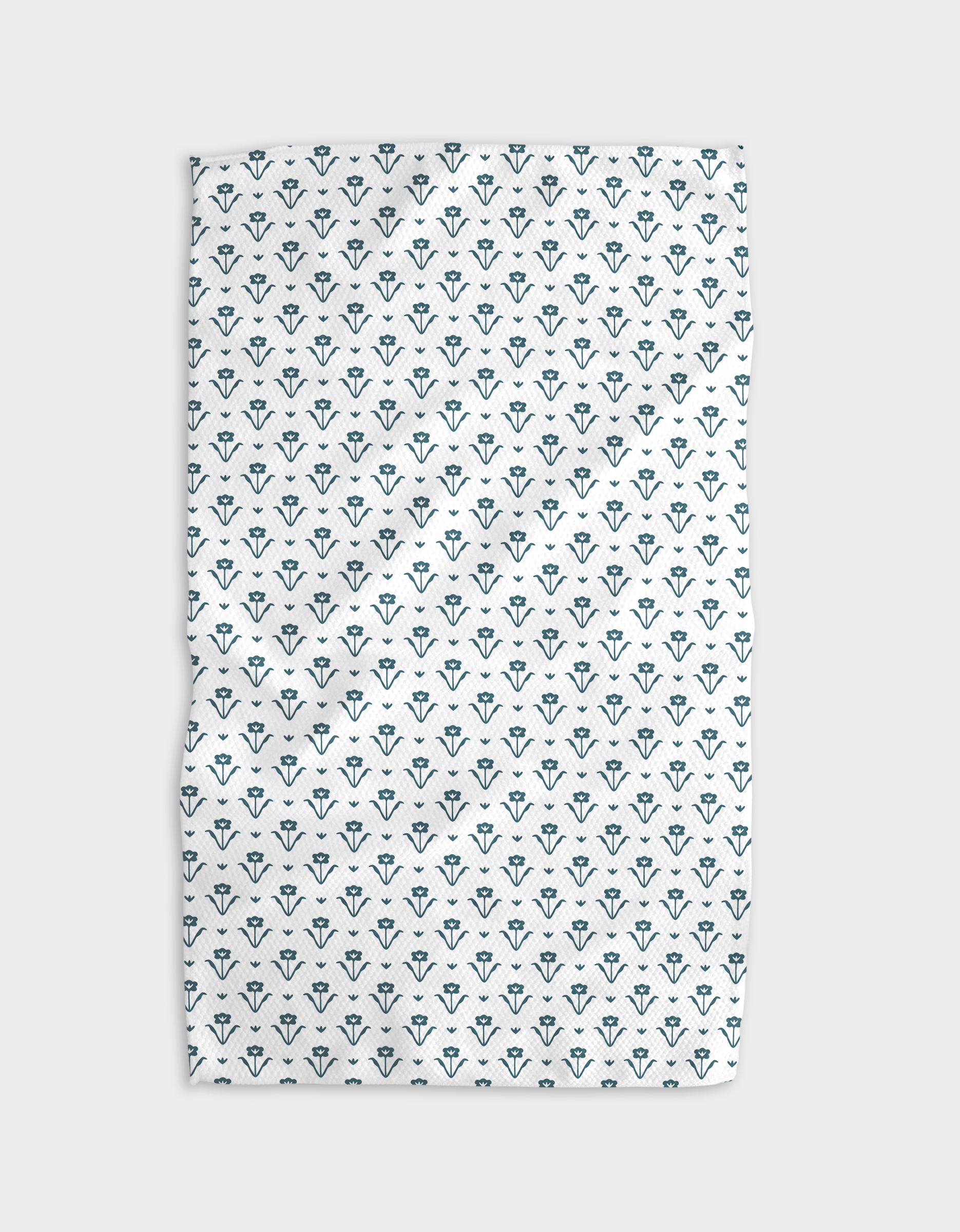 The Buy Guides Ladylike Too - Emerald is a white, quick-drying towel with a repeated small teal floral pattern, shown slightly wrinkled on a neutral background.