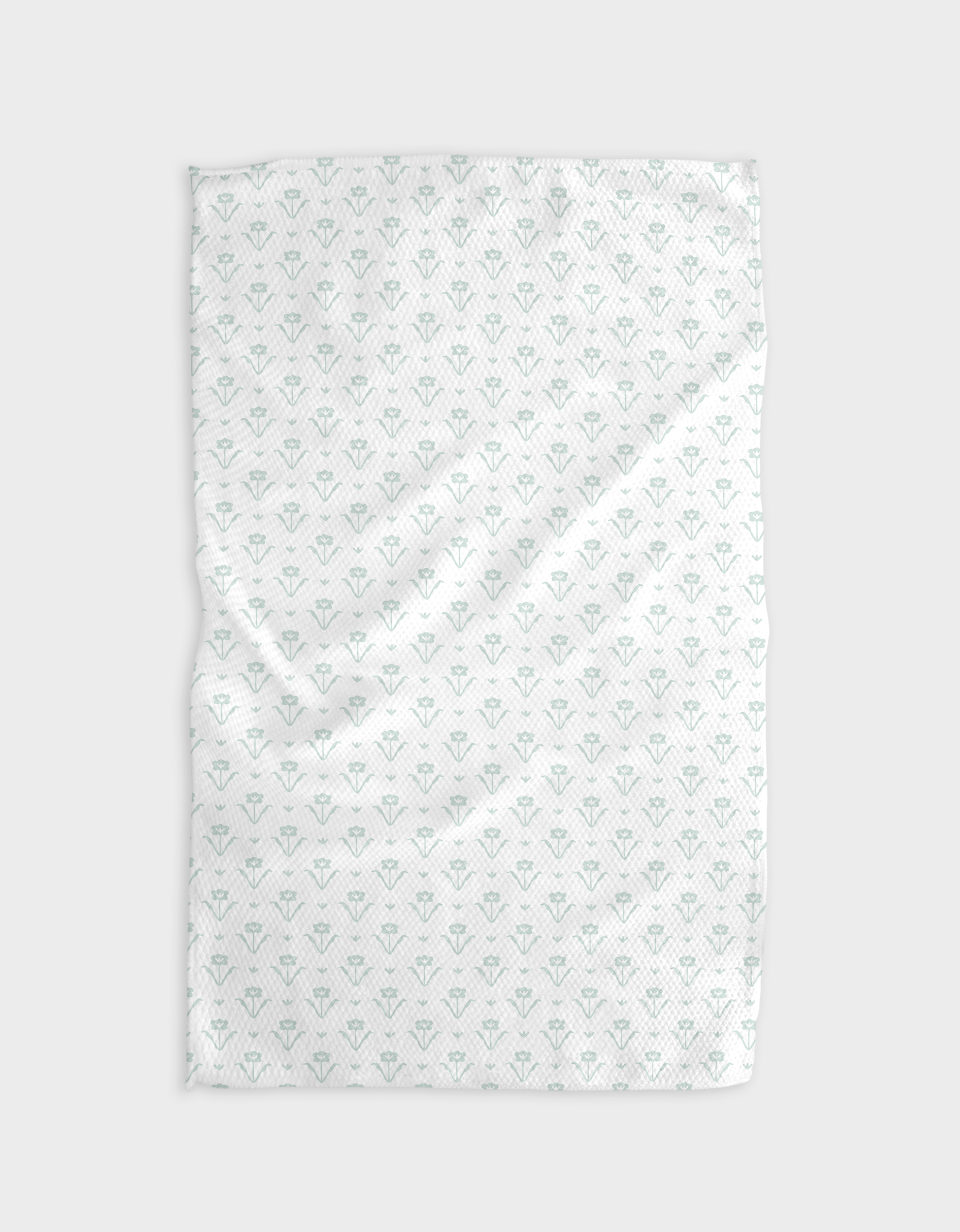 The Buy Guides Ladylike Too - Mint is a white recycled kitchen towel with a subtle pattern of small teal geometric shapes, shown flat on a light gray background.