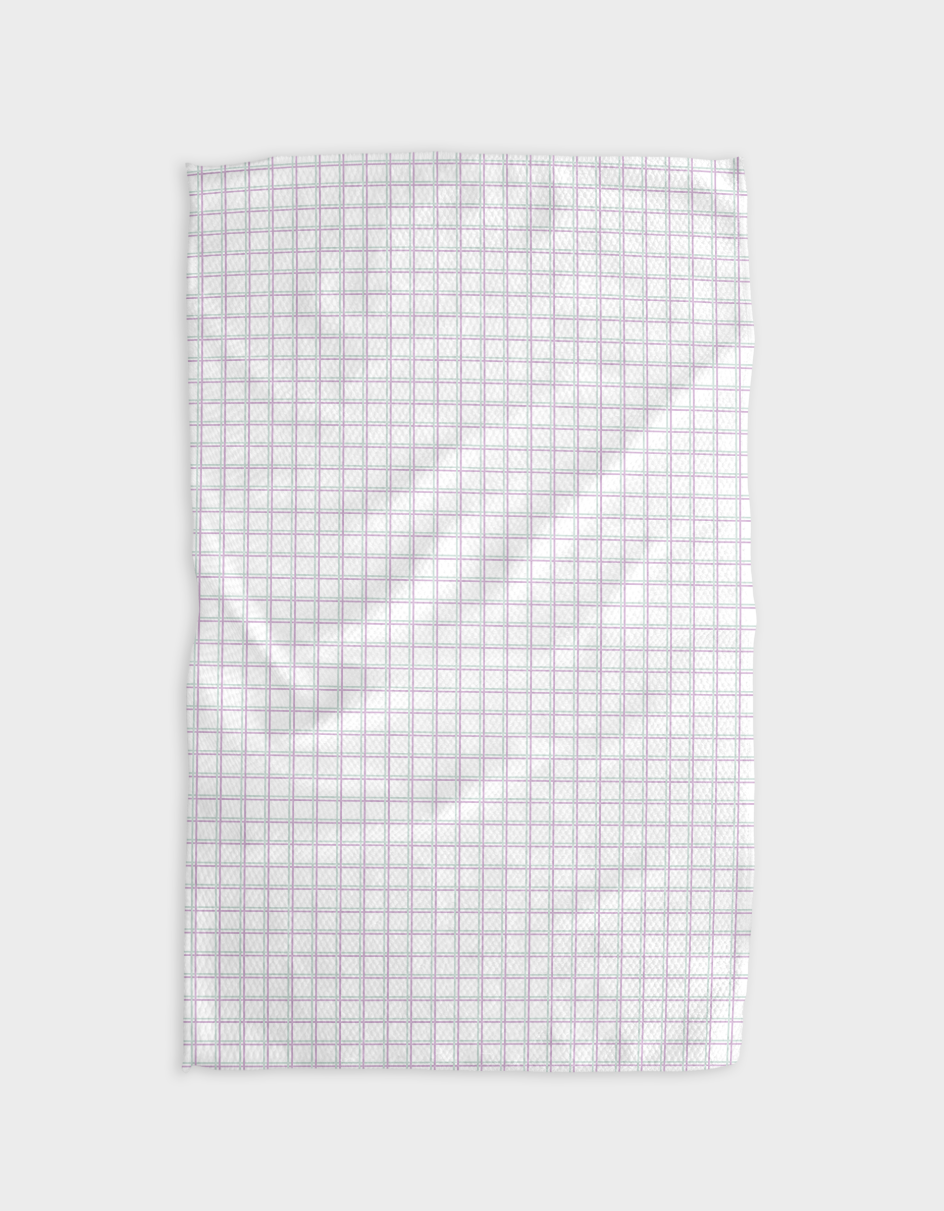 The Buy Guide’s Preppy - Mint Lilac recycled kitchen towel, white and rectangular with a grid of thin purple lines, is laid flat with slight wrinkles on a plain light gray background.