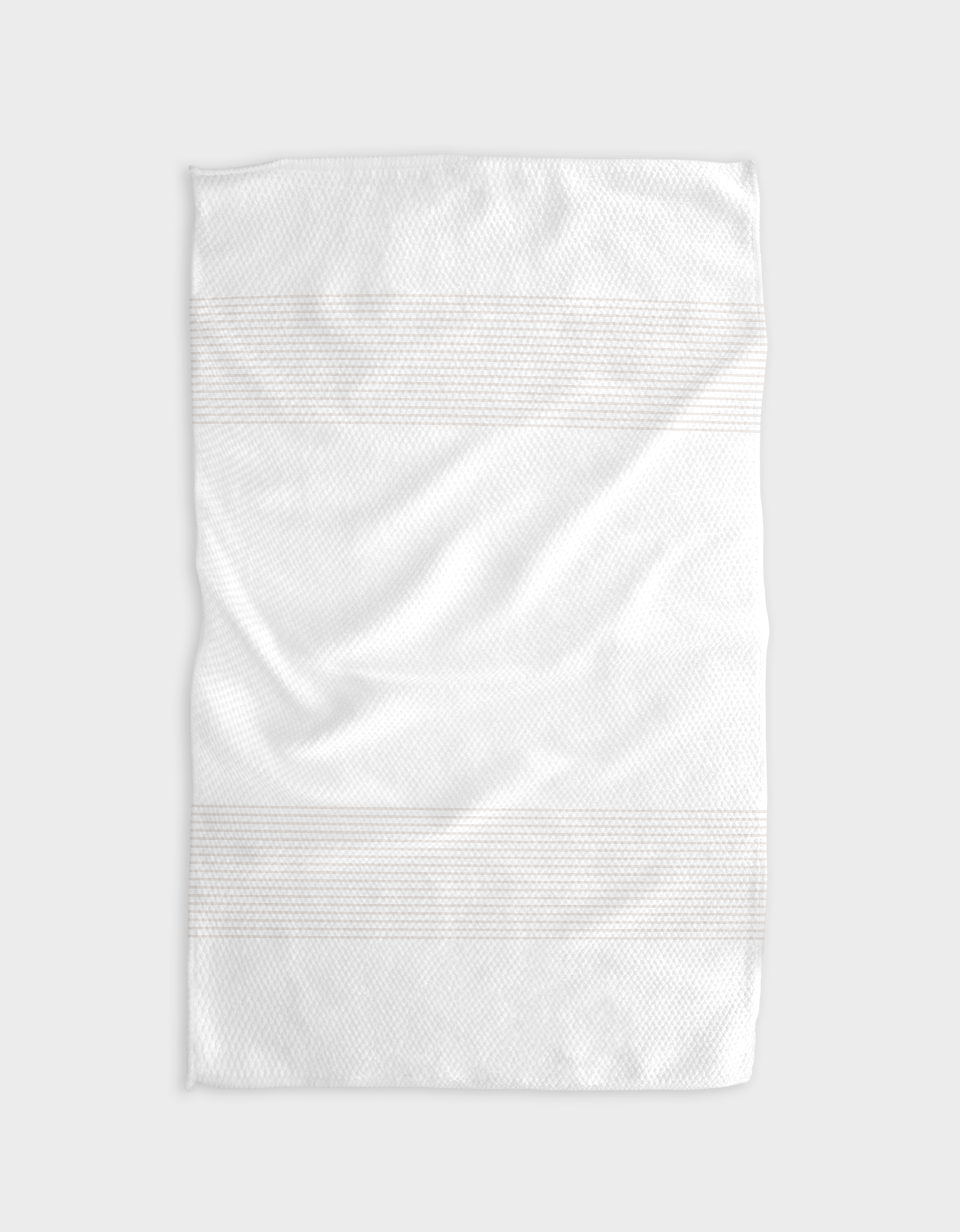 The Buy Guides Blank Space - Beige towel, crafted from ultra-absorbent Geoweave fabric with subtle horizontal stripes, is laid flat on a light gray background, showing soft texture, gentle creases, and a clean appearance.