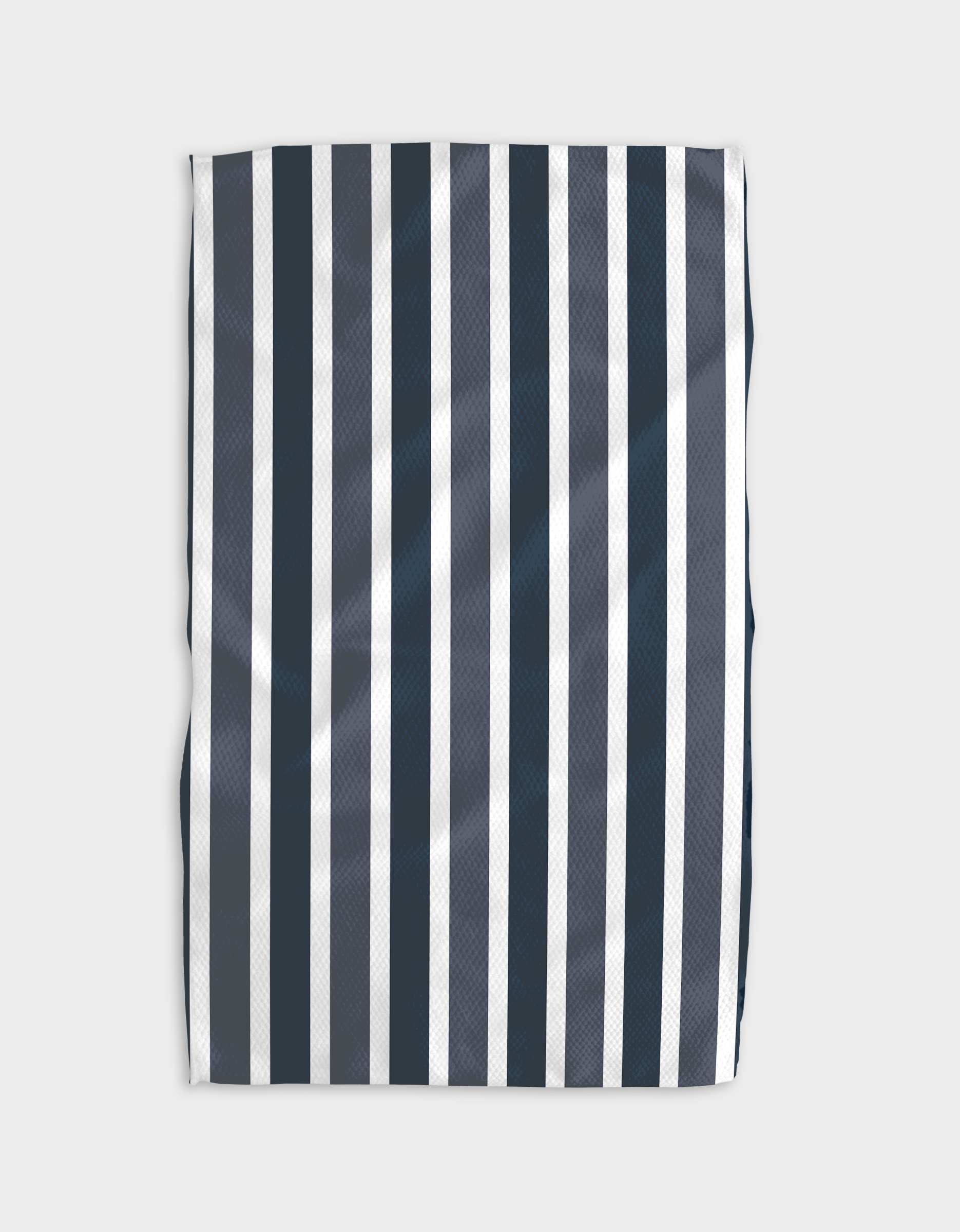 The Buy Guides Earn Your Stripes - Navy tea towel features vertical navy blue and white stripes on light gray Geoweave™ fabric. Rectangular, slightly wrinkled, and shown laying flat.
