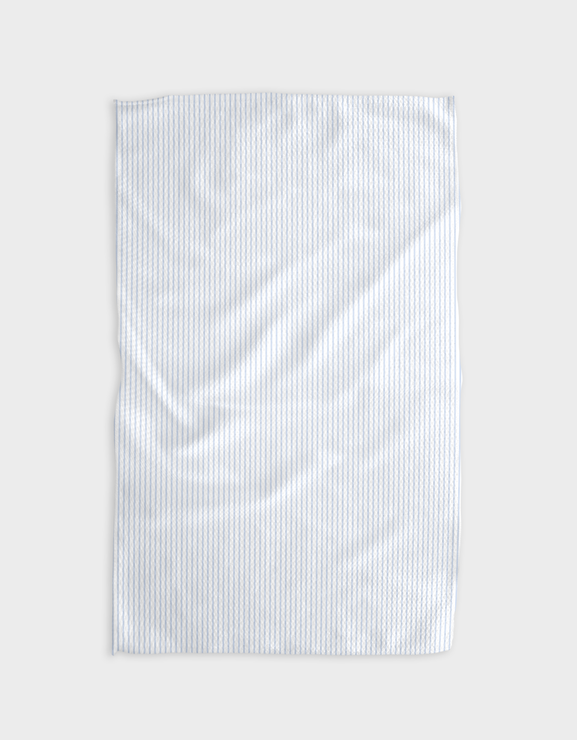 The Buy Guide’s Get In Line - Light Blue recycled kitchen towel features subtle vertical pale blue stripes and a soft, slightly wrinkled texture, shown flat against a plain light gray background.