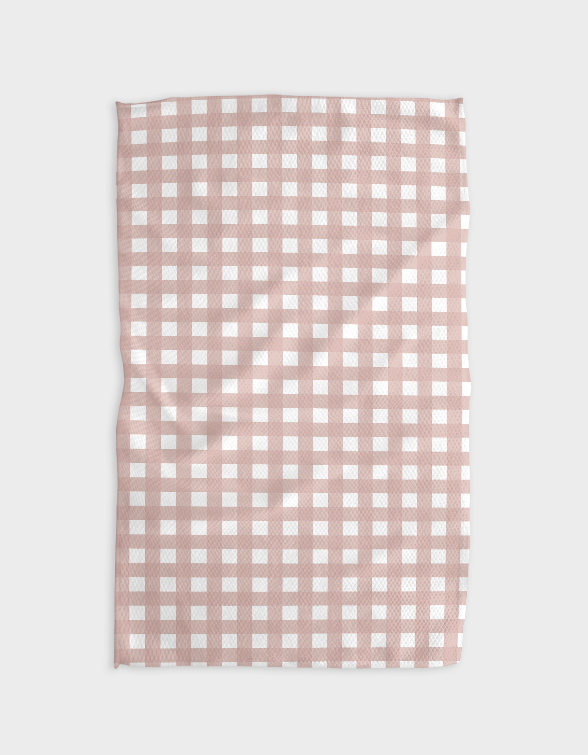 The Buy Guides Gigi - Dusty Rose is a rectangular tea towel made from recycled materials, featuring a pink and white checkered pattern and a slightly wrinkled texture, shown laid flat against a plain white background.