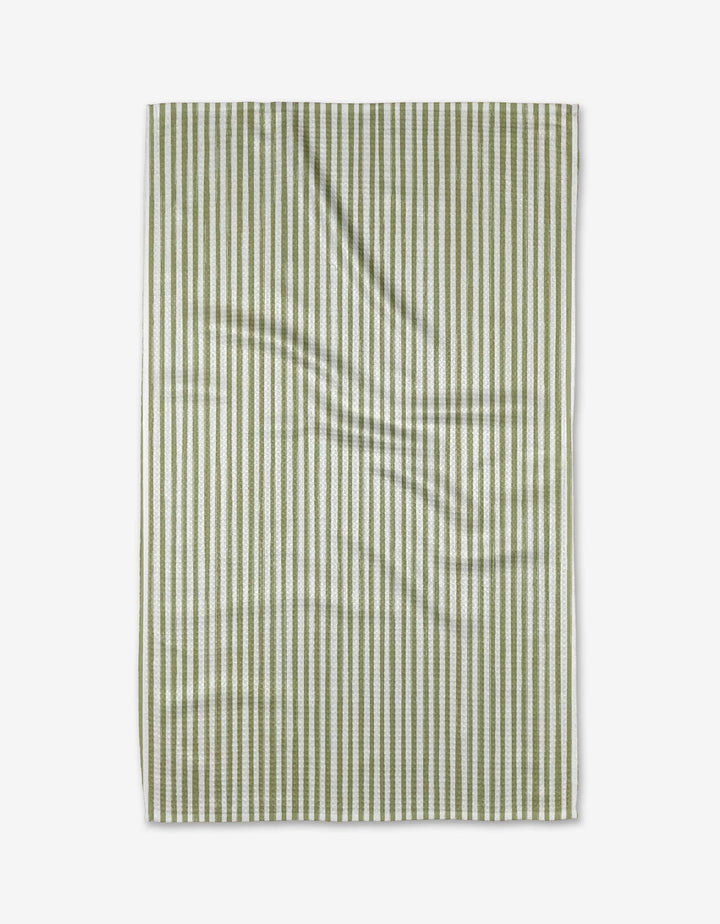 The Kailee Wright Avocado towel, featuring green and white stripes and made from ultra-absorbent Geoweave fabric, is laid flat on a white background with slight surface wrinkles.