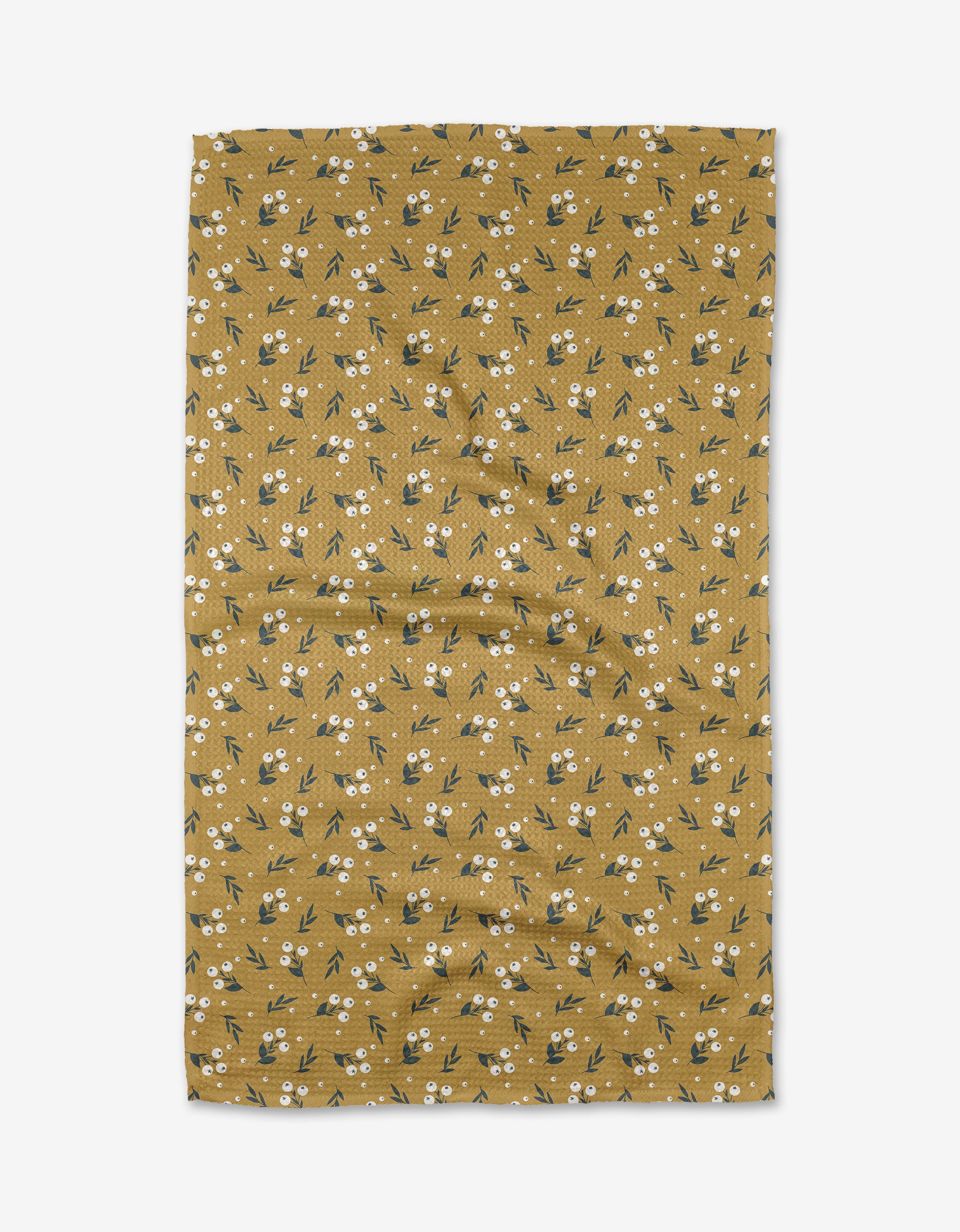 Betty by Charlie Rowan Designs is a mustard yellow Geoweave™ fabric with small white flowers and green leaves, shown flat against a white background with some visible creases.