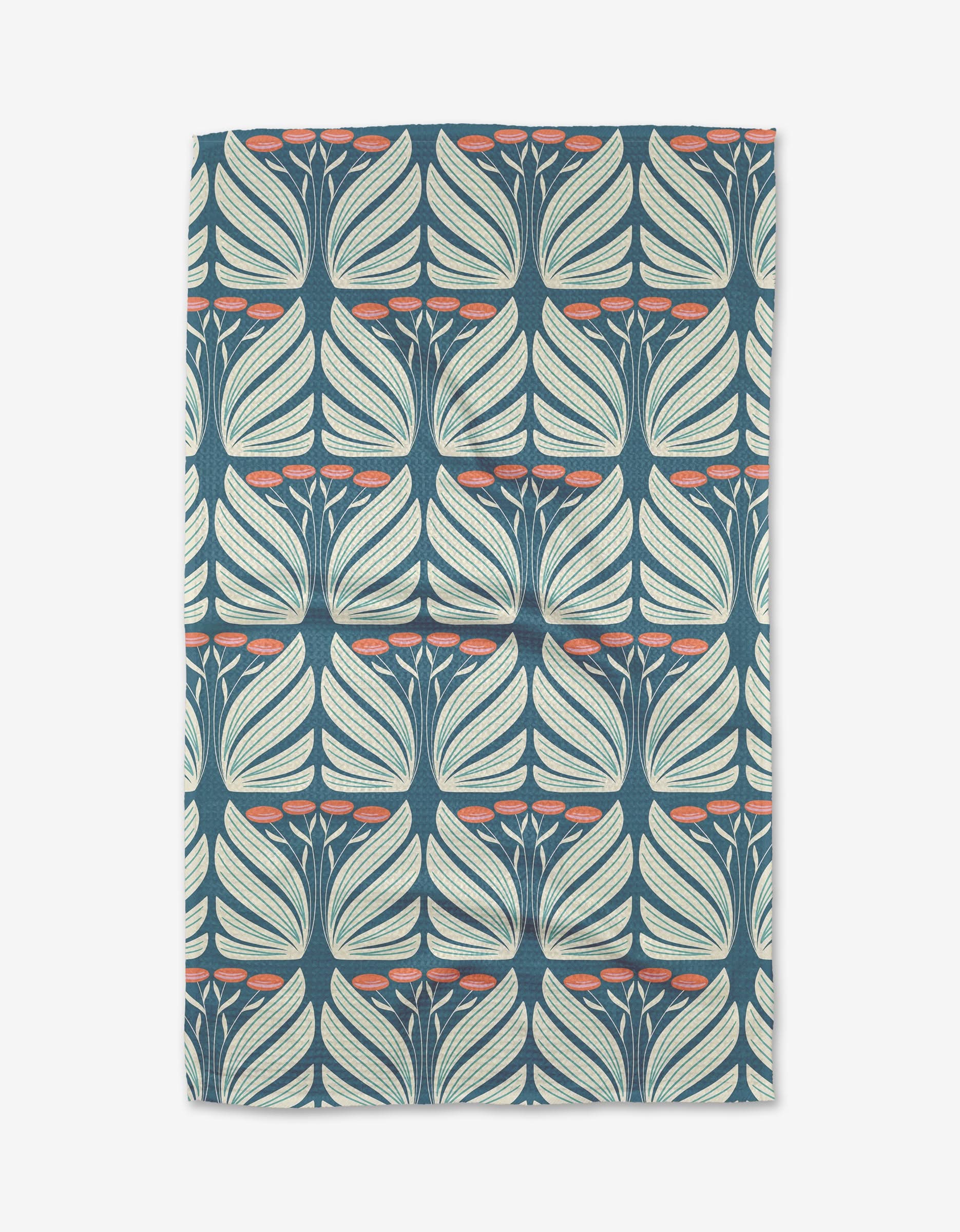 Beyond the Gate by Rebecca Woolbright is a rectangular tea towel with a repeating pattern of cream and light green stylized leaves on dark blue, accented by coral-colored oval clusters.
