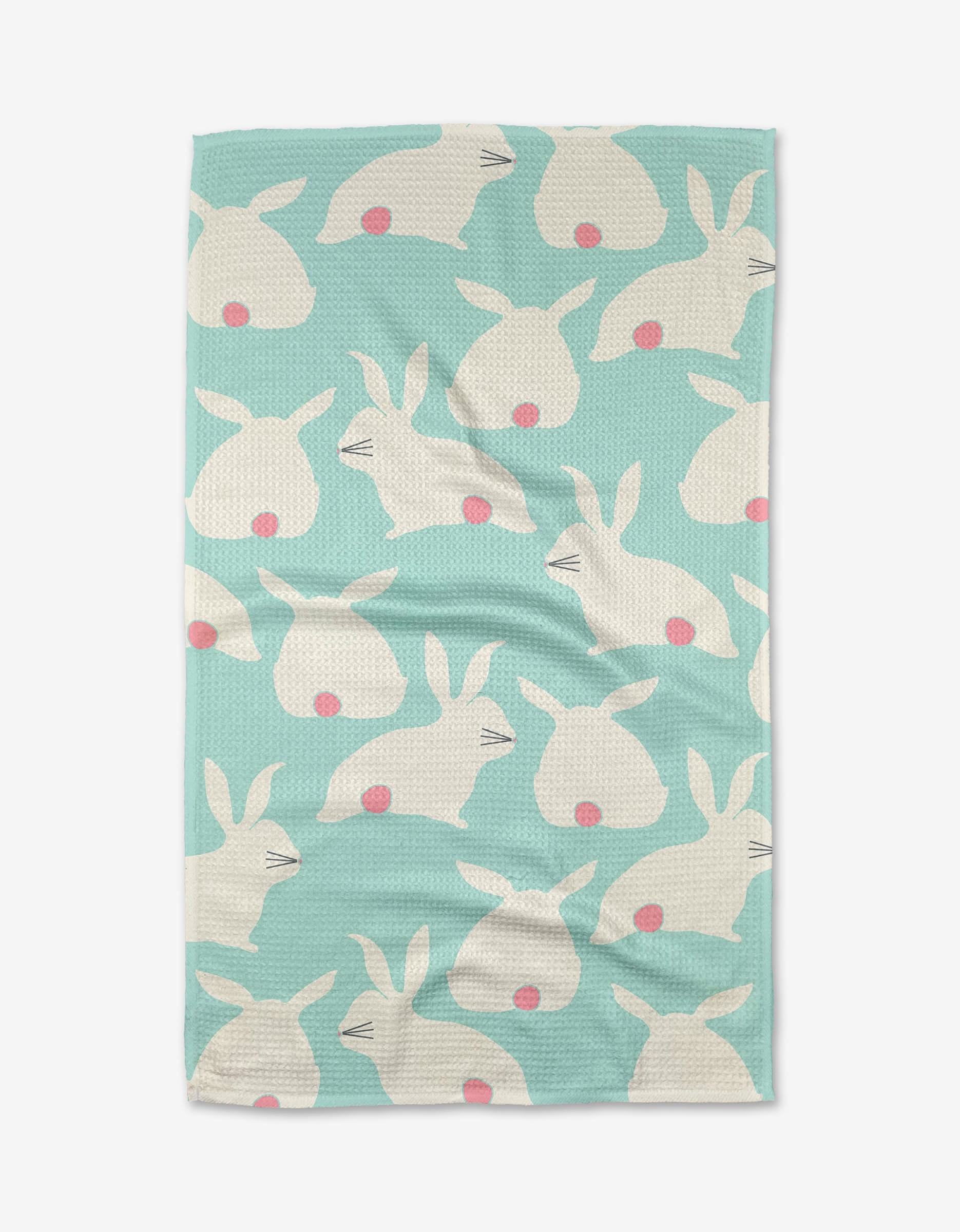 The Bunny Rabbit Races towel by Lizzie Clark is light blue and ultra-absorbent, featuring a repeating pattern of white bunny heads with closed eyes and pink noses in various directions.