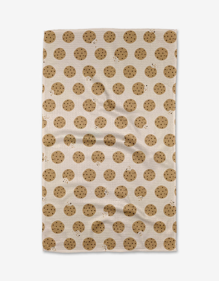 The Purely Kaylie Cookie Crumble tea towel, crafted from Geoweave fabric, showcases an all-over chocolate chip cookie pattern and is displayed flat.