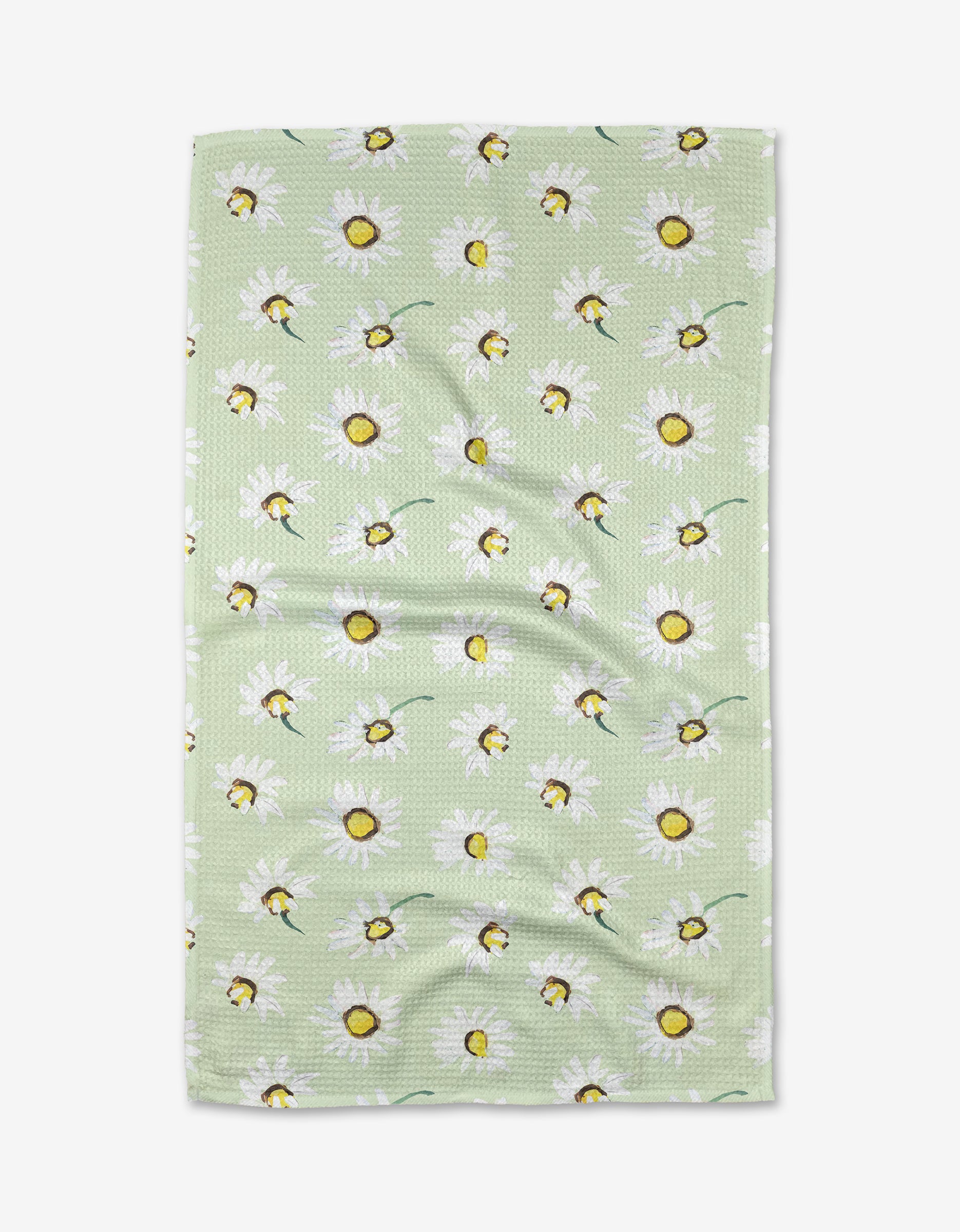The Daisy Field tea towel by Ania Zwara Art features white daisies with yellow centers on green Geoweave fabric and a charming, slightly wrinkled texture.