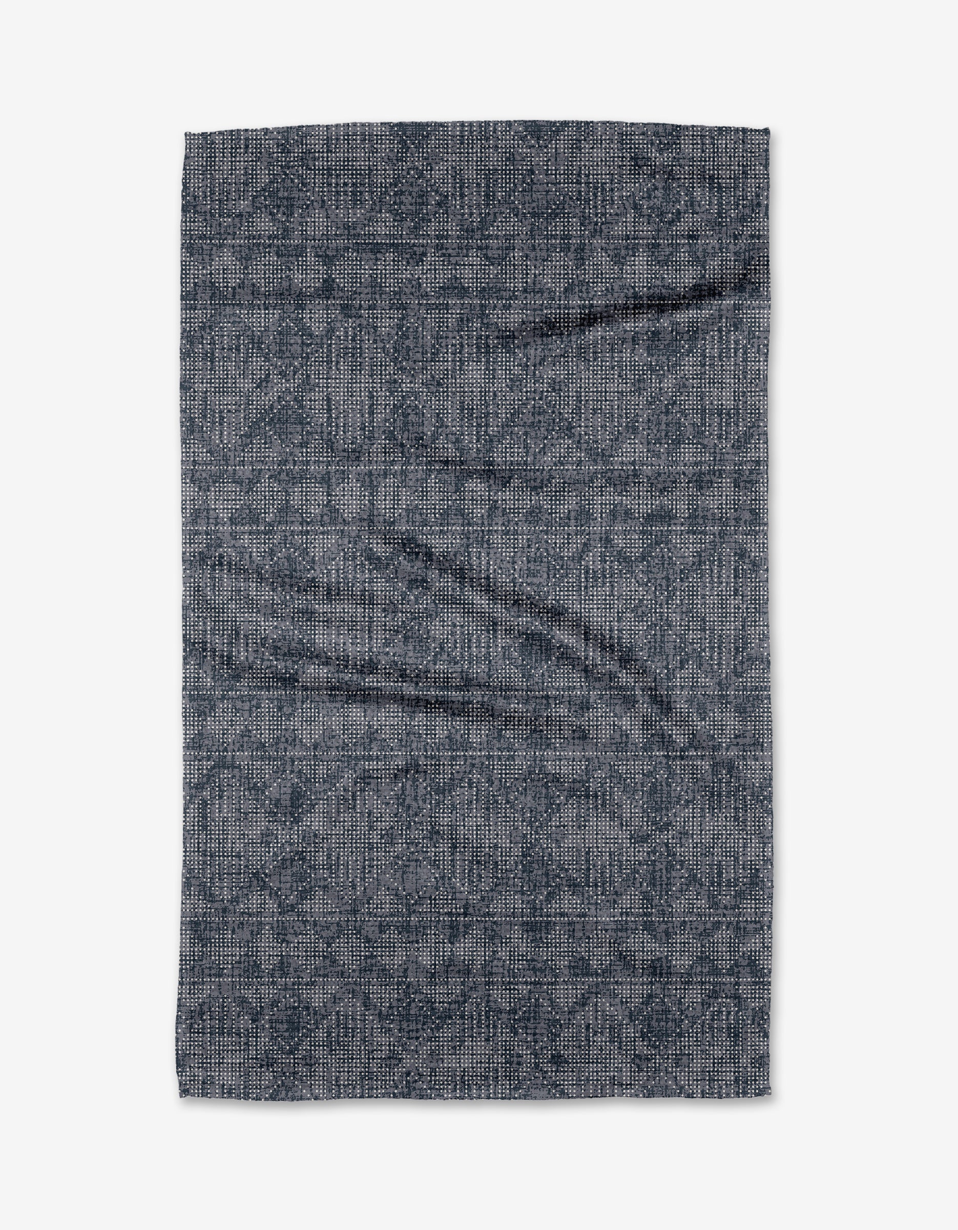 A rectangular Debra Blue tea towel by Becki Owens, featuring a dark blue and gray geometric pattern with slight wrinkles, made from soft Geoweave fabric, is shown flat on a white background.