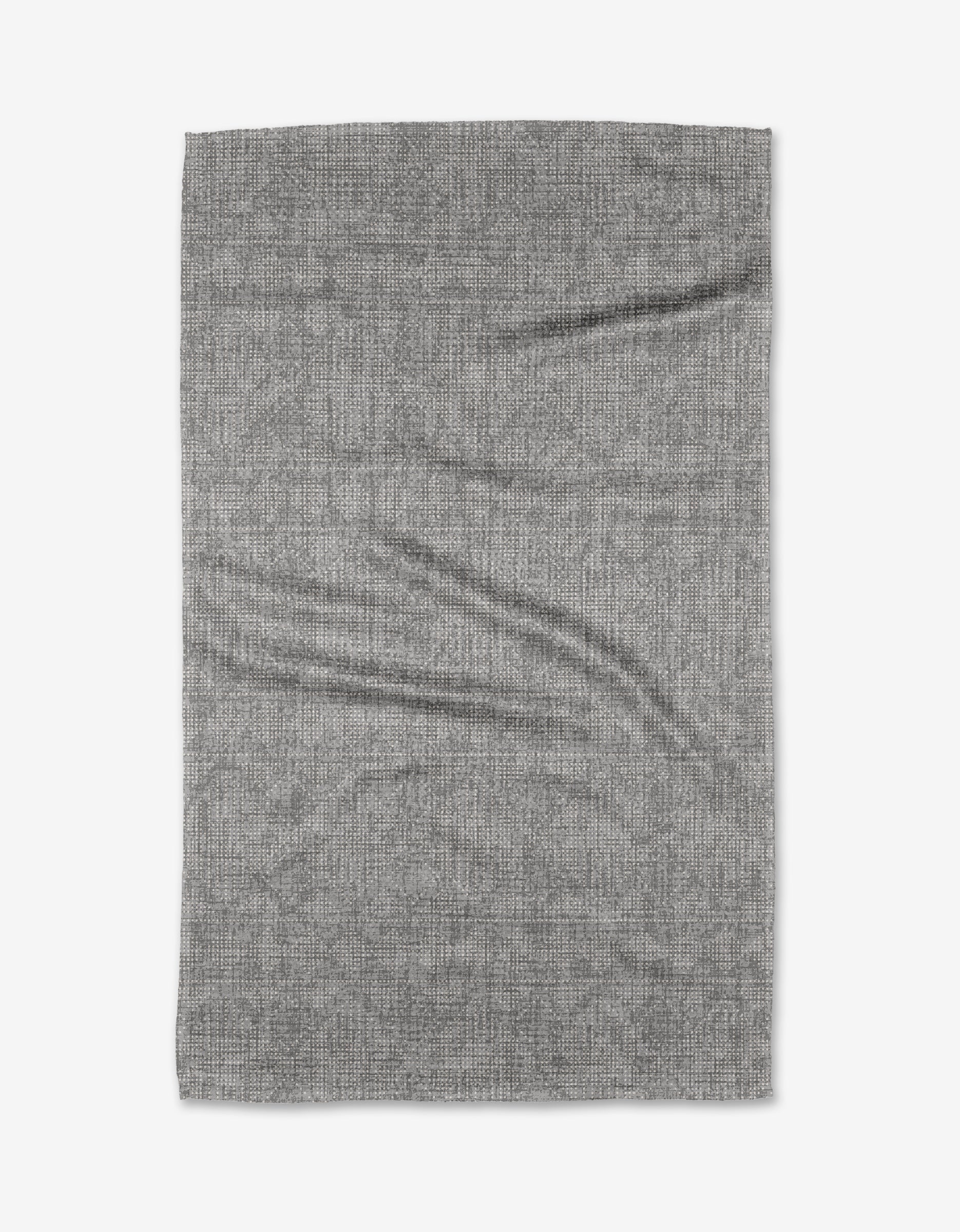 The Debra Grey Tea Towel by Becki Owens is rectangular, light gray, and made from soft Geoweave™ fabric with a subtle woven texture and slight creases, shown laid flat on a white background.