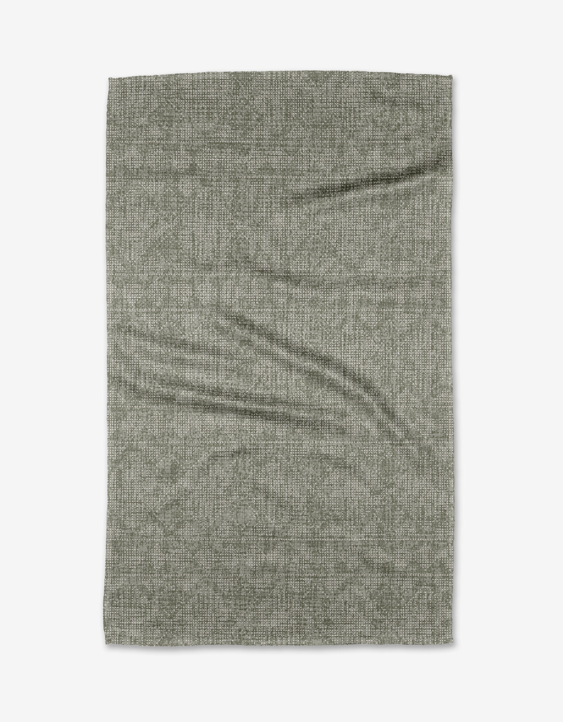 The Debra Sage tea towel by Becki Owens is a rectangular, textured gray piece made from recycled materials, shown laid flat on a white background with visible creases and folds.
