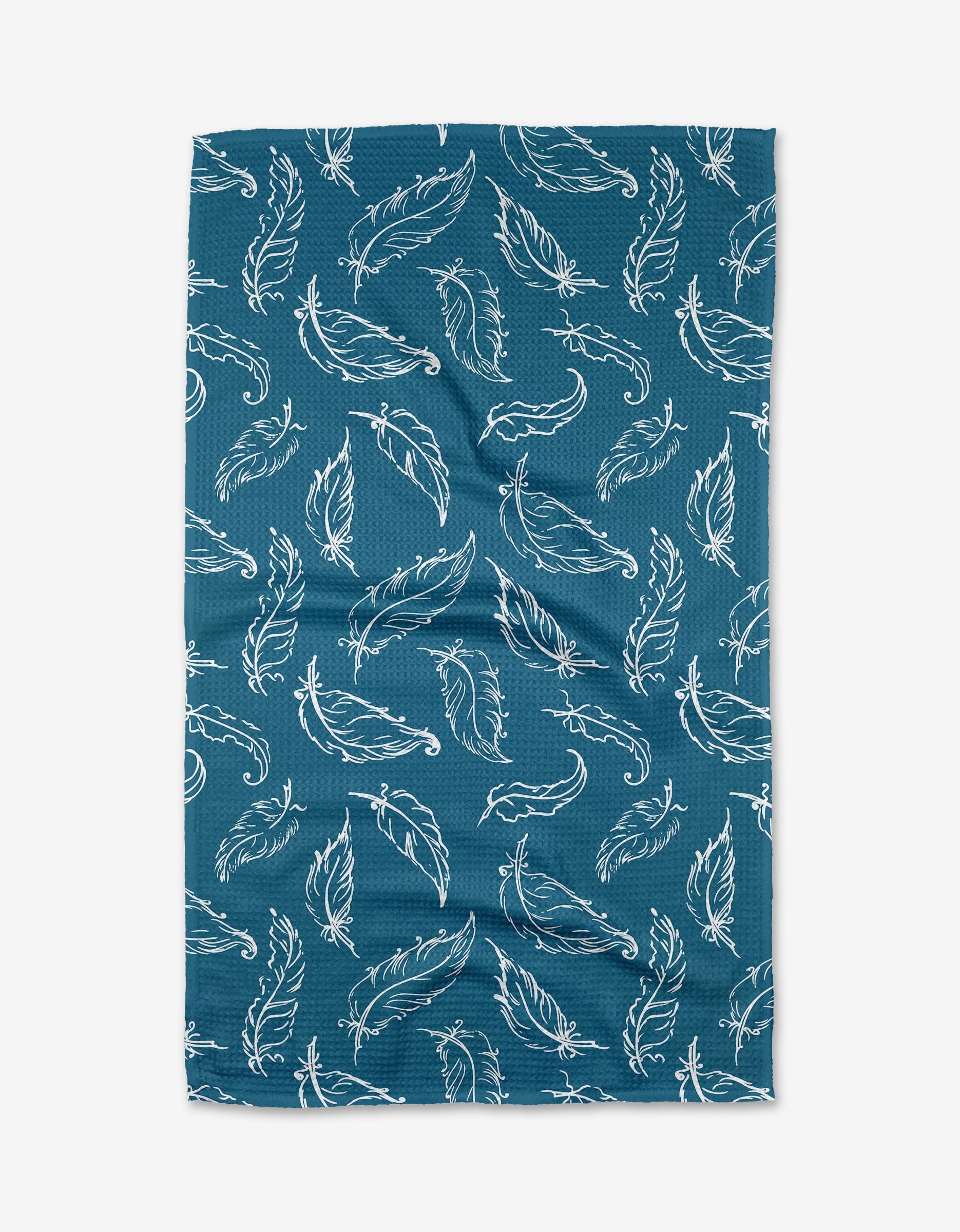The Elena Fay Delicate Feathers tea towel, with a blue background and white hand-drawn feather pattern, is shown against a white backdrop. Slight wrinkles in the ultra-absorbent fabric add texture and charm to this stylish kitchen accessory.
