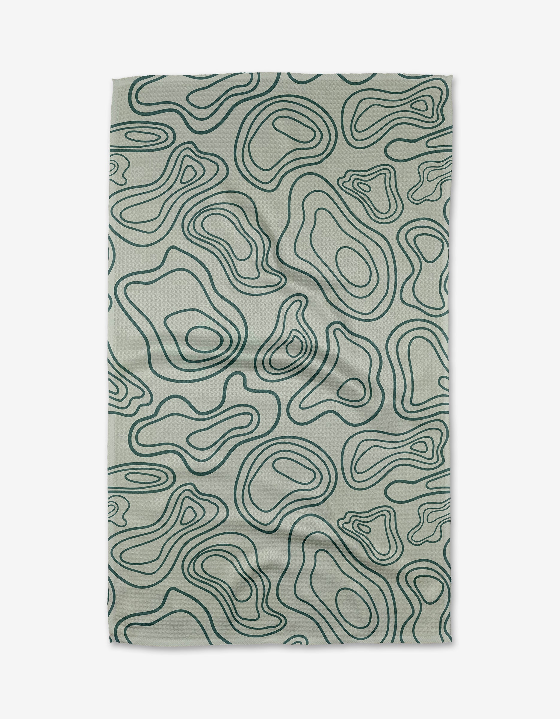 The Twig + Spark Depth Chart tea towel is light grey and rectangular, featuring a dark green abstract topographic line pattern, and is crafted from ultra-absorbent recycled materials.