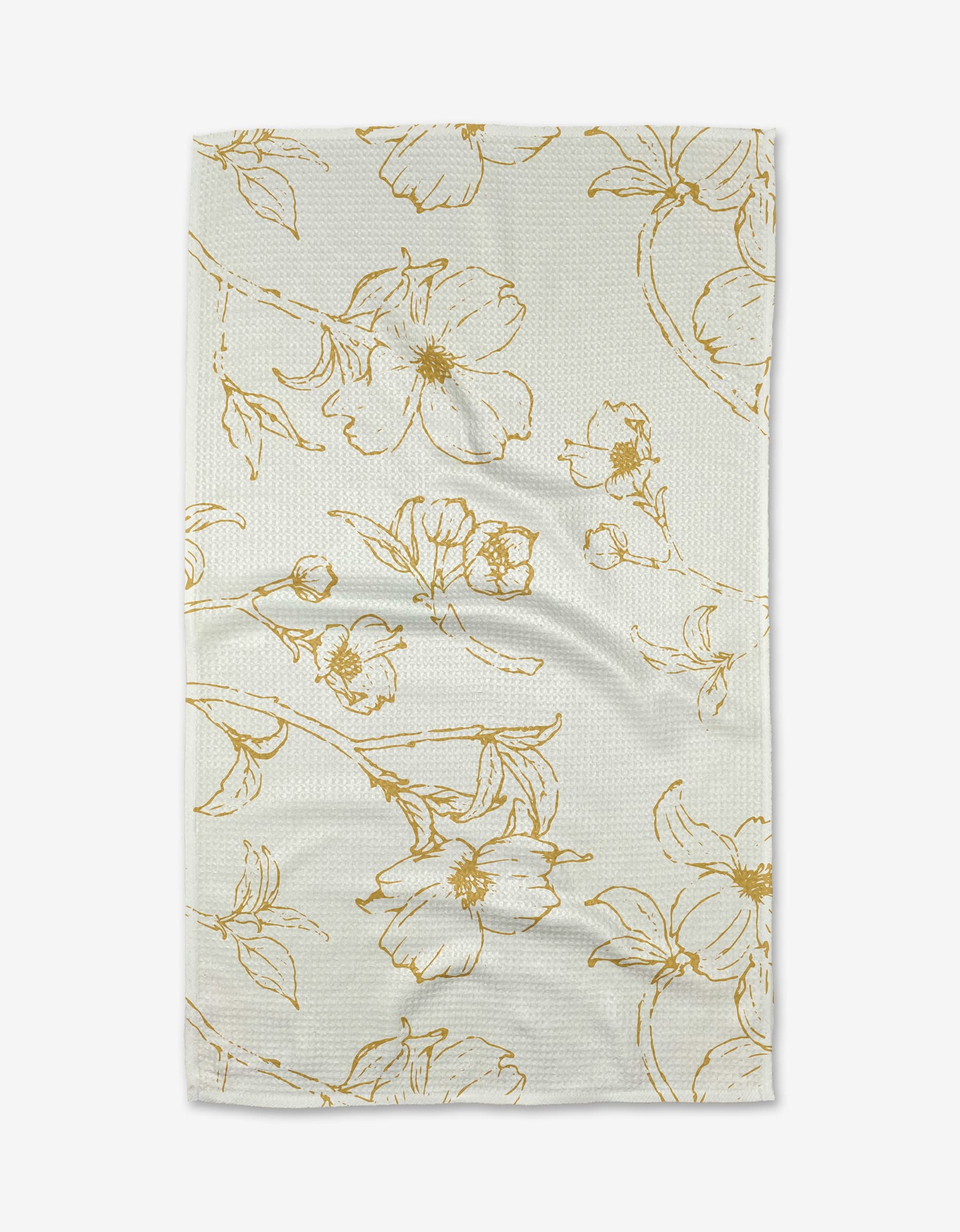 The Early Blossoms tea towel by Ashley Celena is light-colored, ultra-absorbent, and textured, featuring an elegant gold floral design—perfect for adding style to any kitchen.