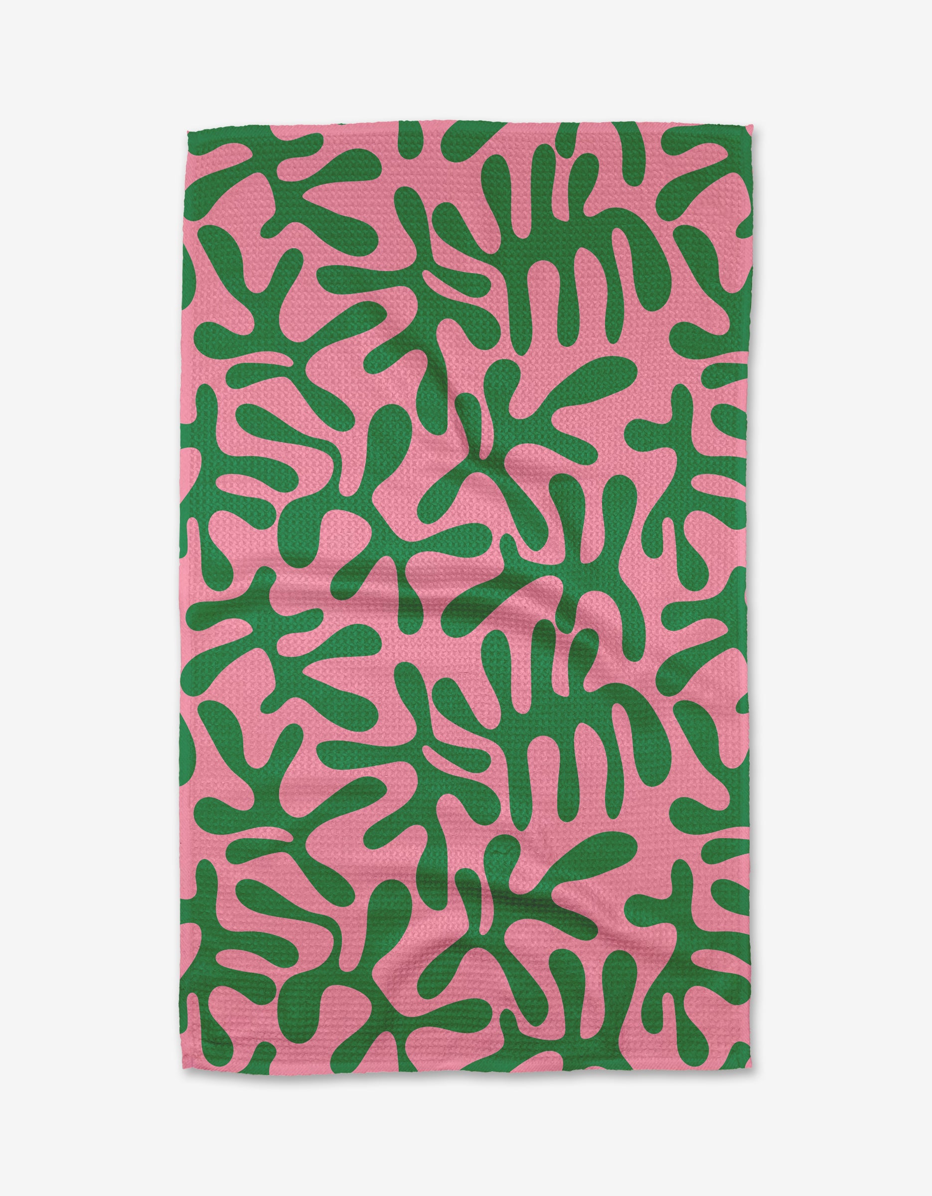 The Early Morning Plants tea towel by Marina Solodka features a rectangular design with an abstract green organic pattern on a pink background, made from recycled materials.