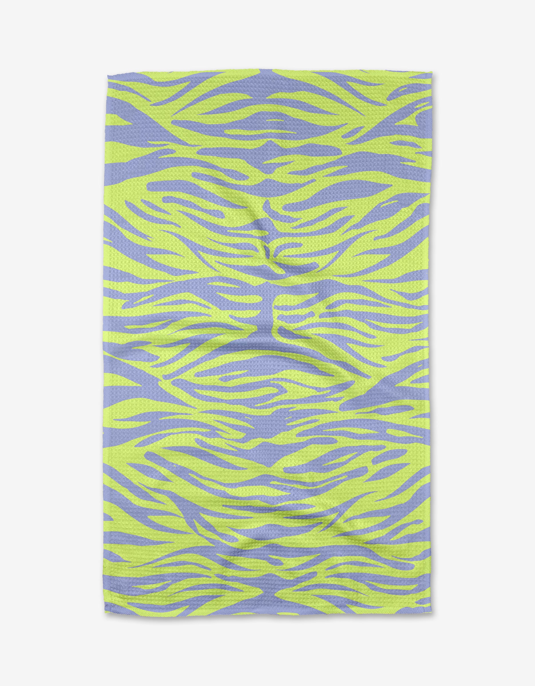 The Electric Tiger tea towel by Elisabeth Wing features a wavy, abstract zebra stripe pattern in lime green and lavender on textured Geoweave fabric.