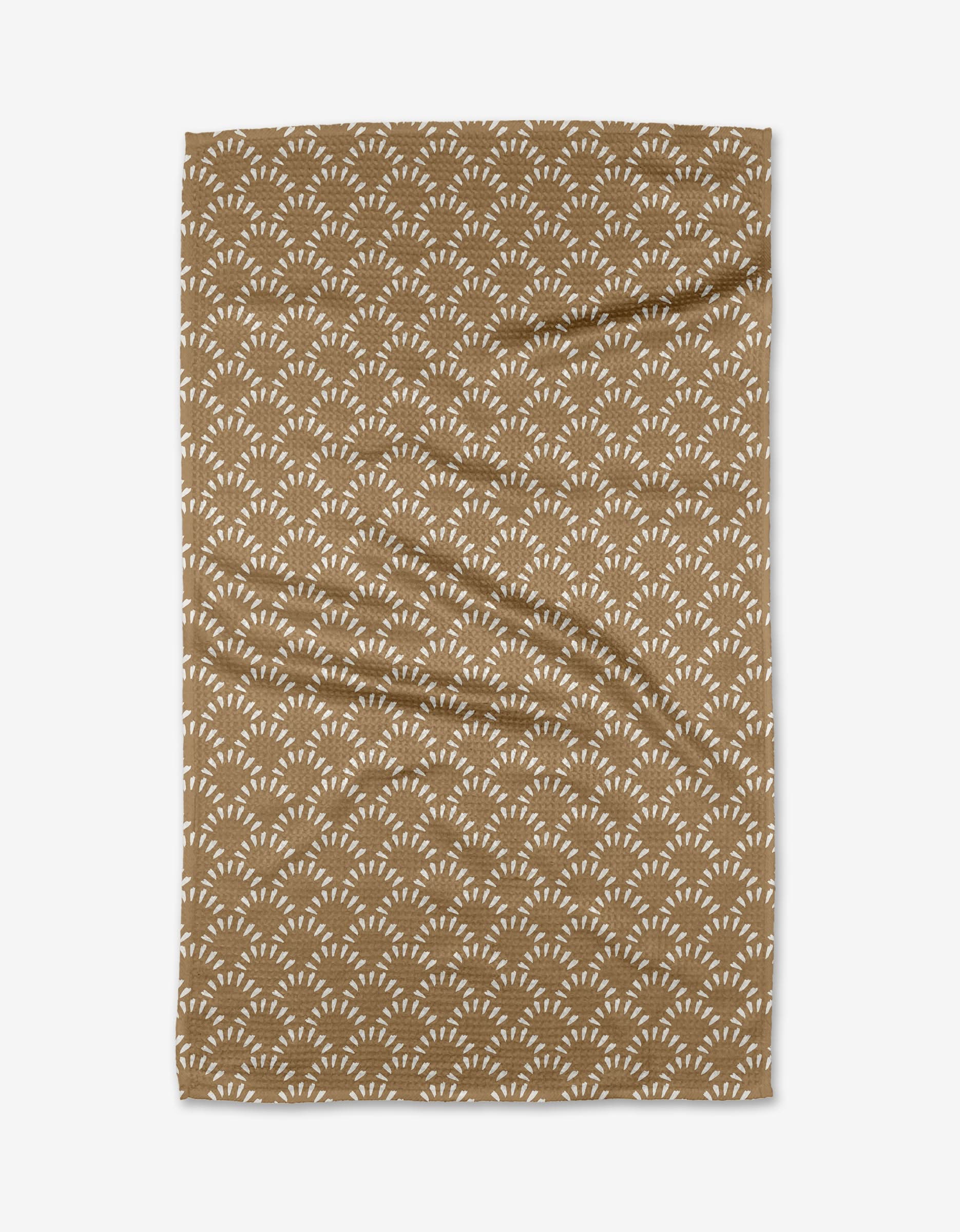 The Fantail towel by Hufton Studio is a brown, rectangular design with a repeating white fan-shaped pattern, made from ultra-absorbent materials and shown on a white background.