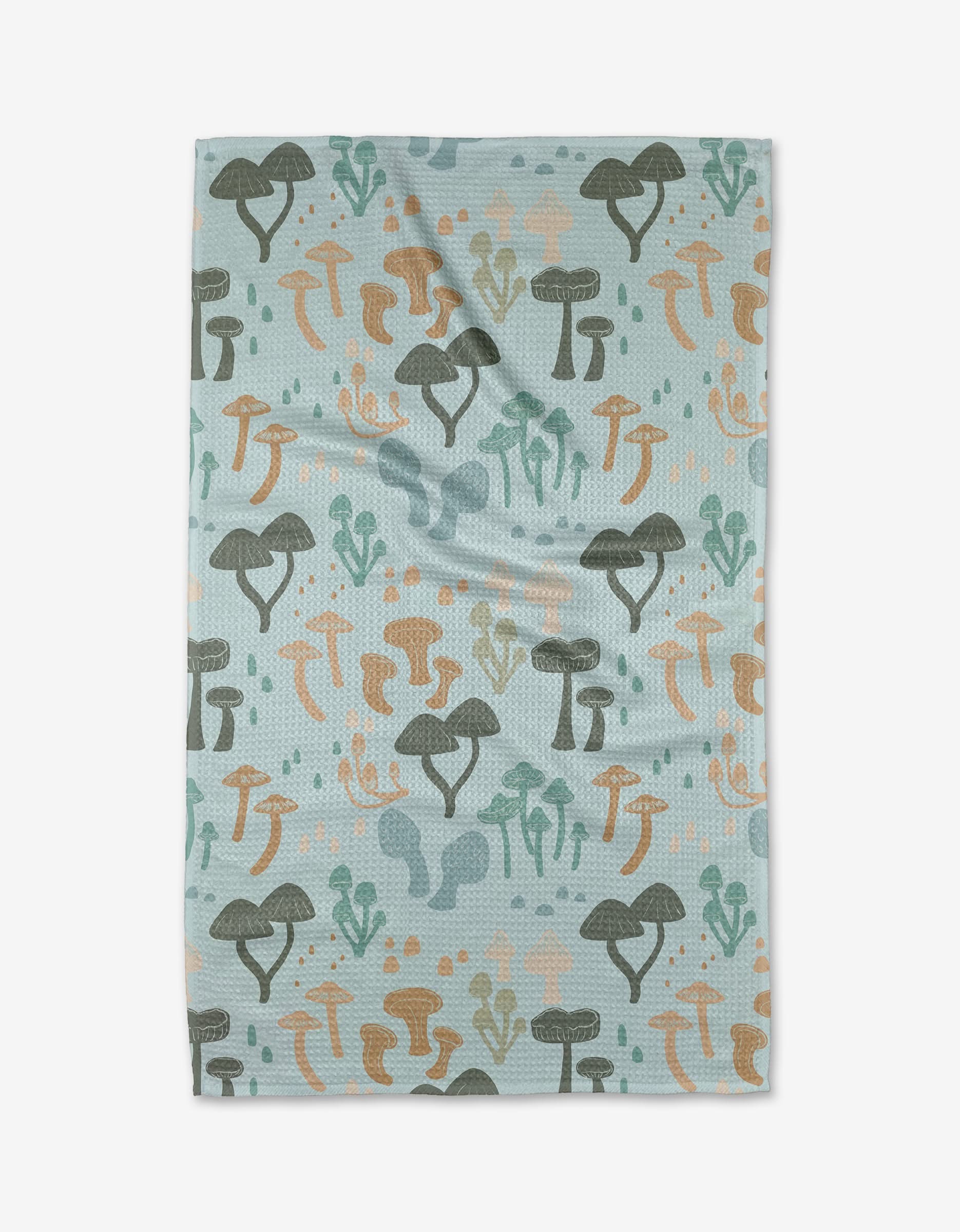 The Forest Friends Tea Towel by Amberleigh Adoff is a rectangular, light blue towel with a repeating green, brown, and orange mushroom pattern. Ultra-absorbent with a soft look, it’s perfect for any kitchen.