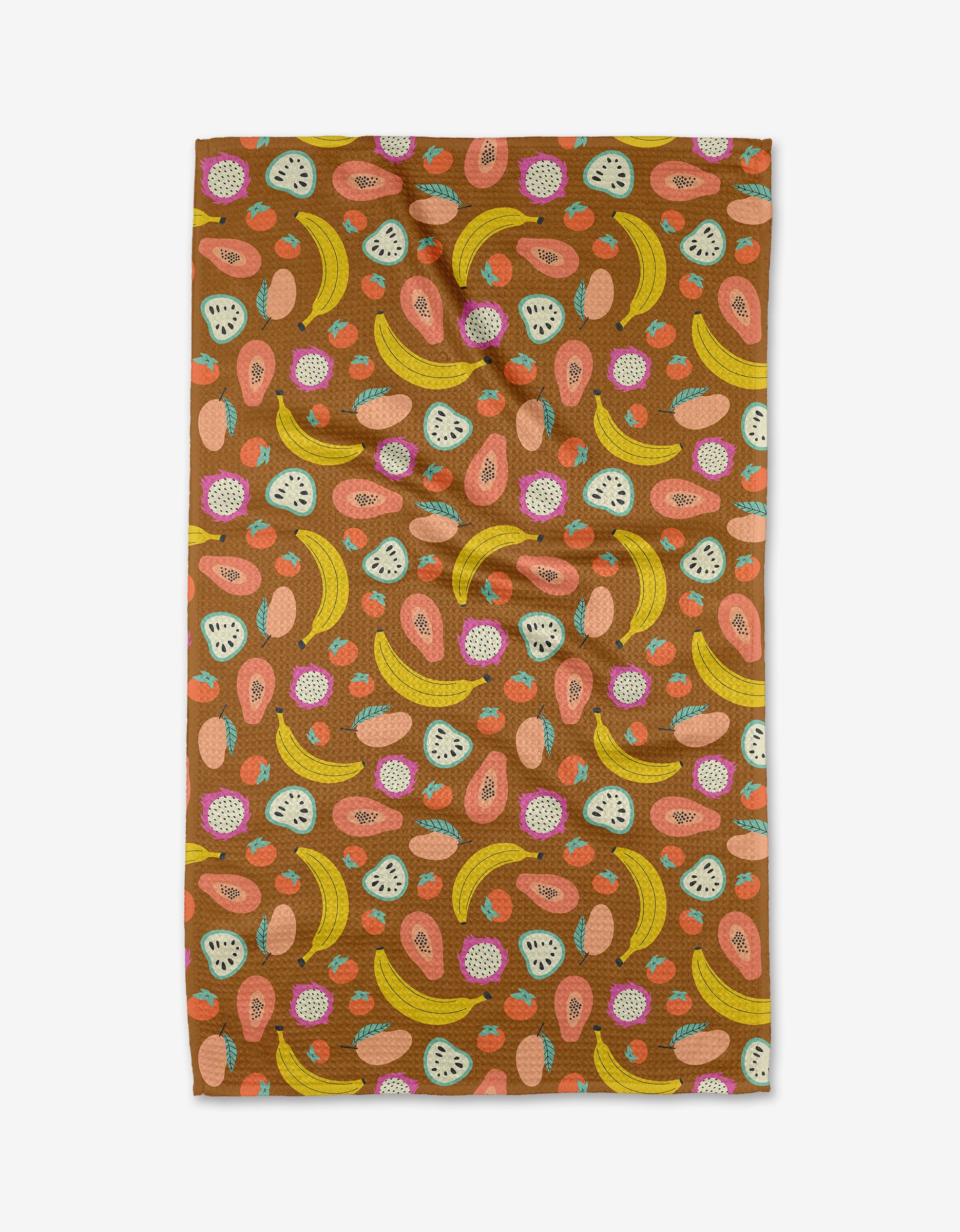 The Fruit Salad tea towel by Megan Kampa displays a vibrant fruit pattern of bananas, papayas, dragon fruit, and passion fruit on brown Geoweave™ fabric, shown flat on a white surface.
