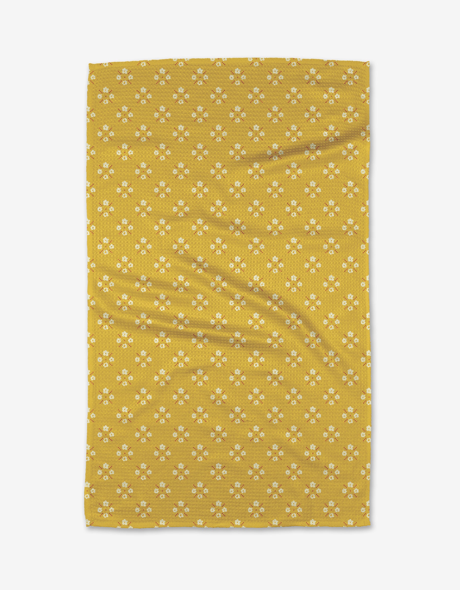 The Garden Lattice Tea Towel by Kelsey Weigl features yellow Geoweave™ fabric with a repeating pattern of small white and yellow flowers, shown flat with slight creases.