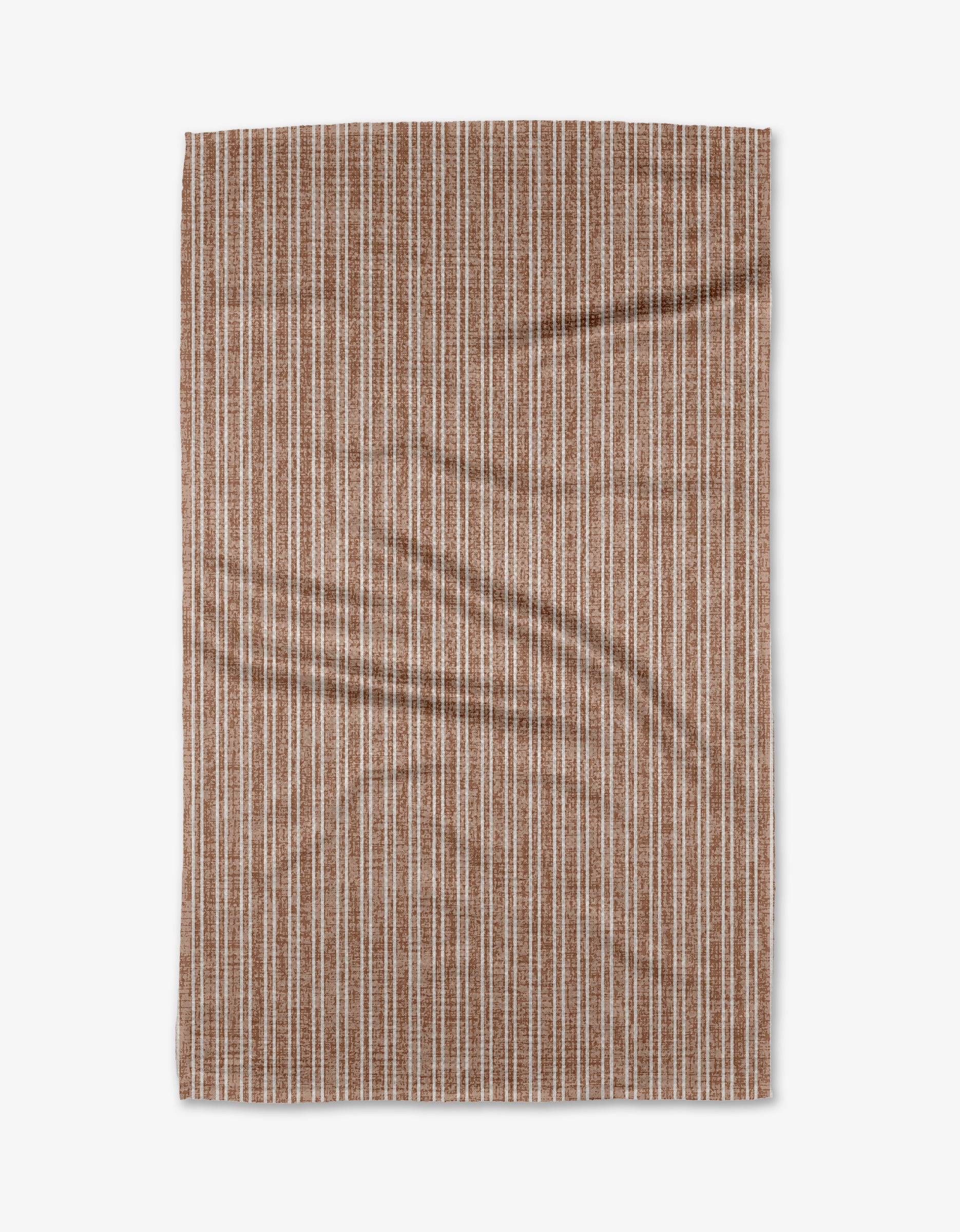 The Garff Rust by Becki Owens is a rectangular Geoweave fabric with a brown background and vertical white dashed stripes, shown laid flat with slight wrinkles on a plain white surface.