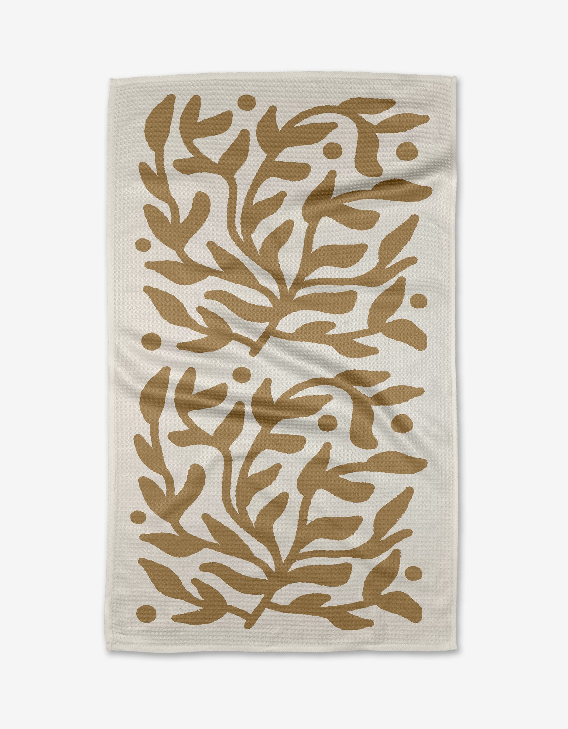 The Golden Garden tea towel by Graphics and Grain features a white, textured Geoweave fabric with symmetrical abstract brown leaves and dots in mirrored sections for durability and softness.