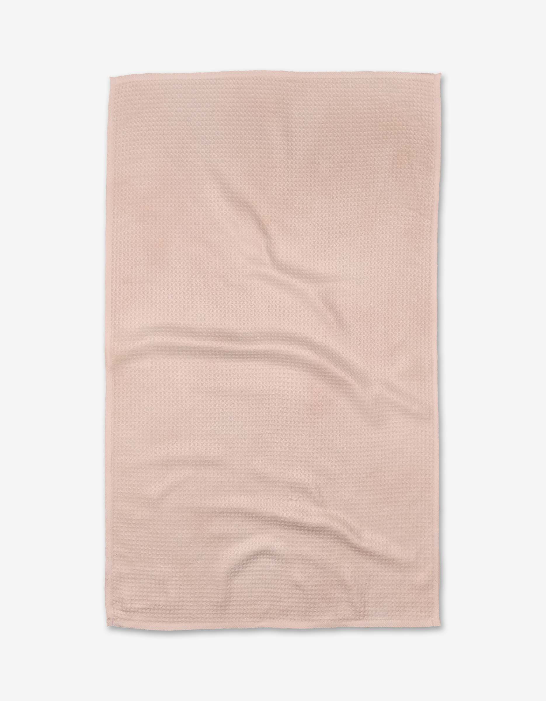 The Harper Pink tea towel by Kailee Wright features a light pink, rectangular design with a subtle textured pattern. Made from ultra-absorbent Geoweave™ fabric for efficient drying, its shown flat with slight wrinkles on a white background.